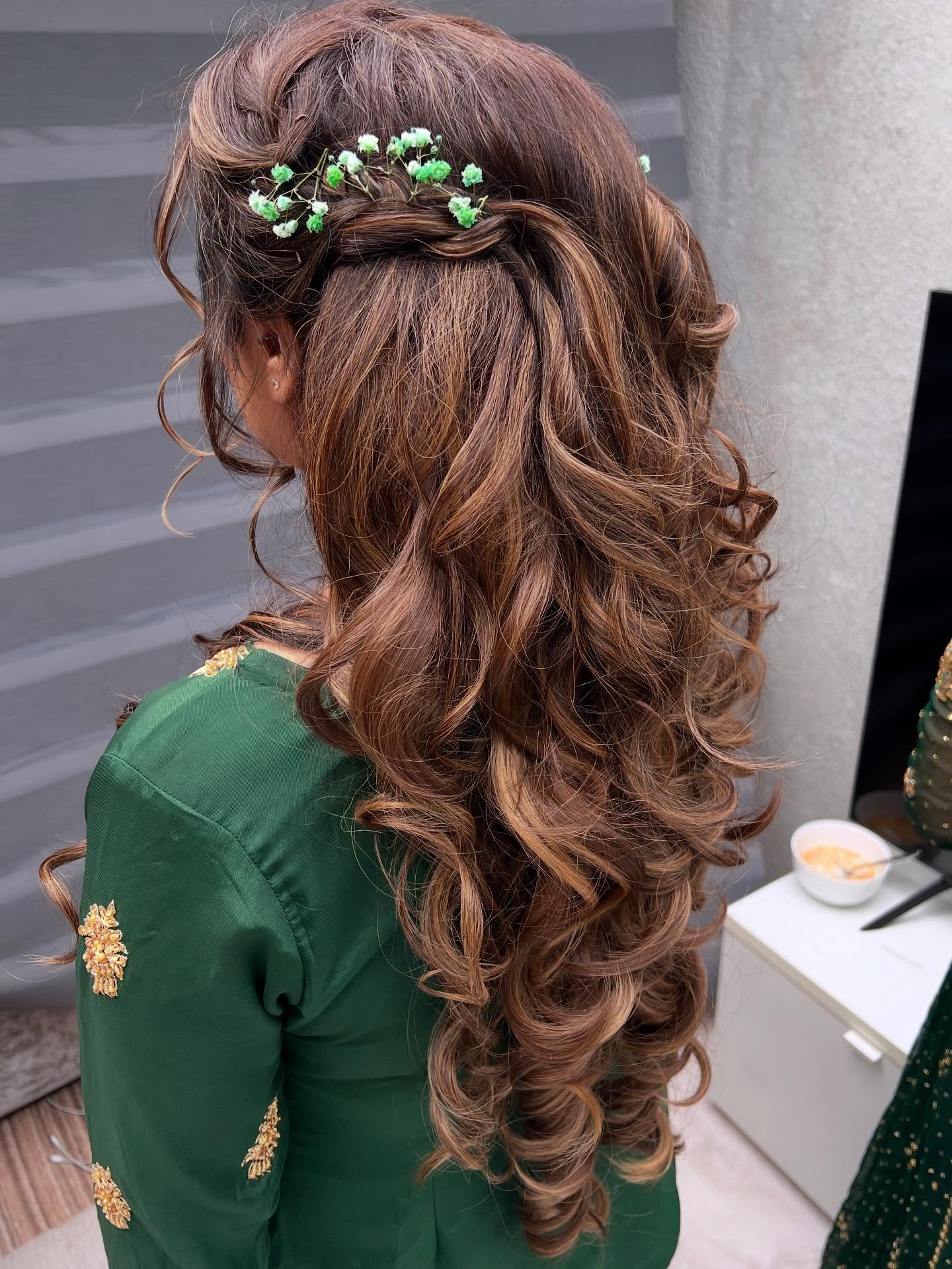 Whimsical Curly Tresses with Green Blossom Accents