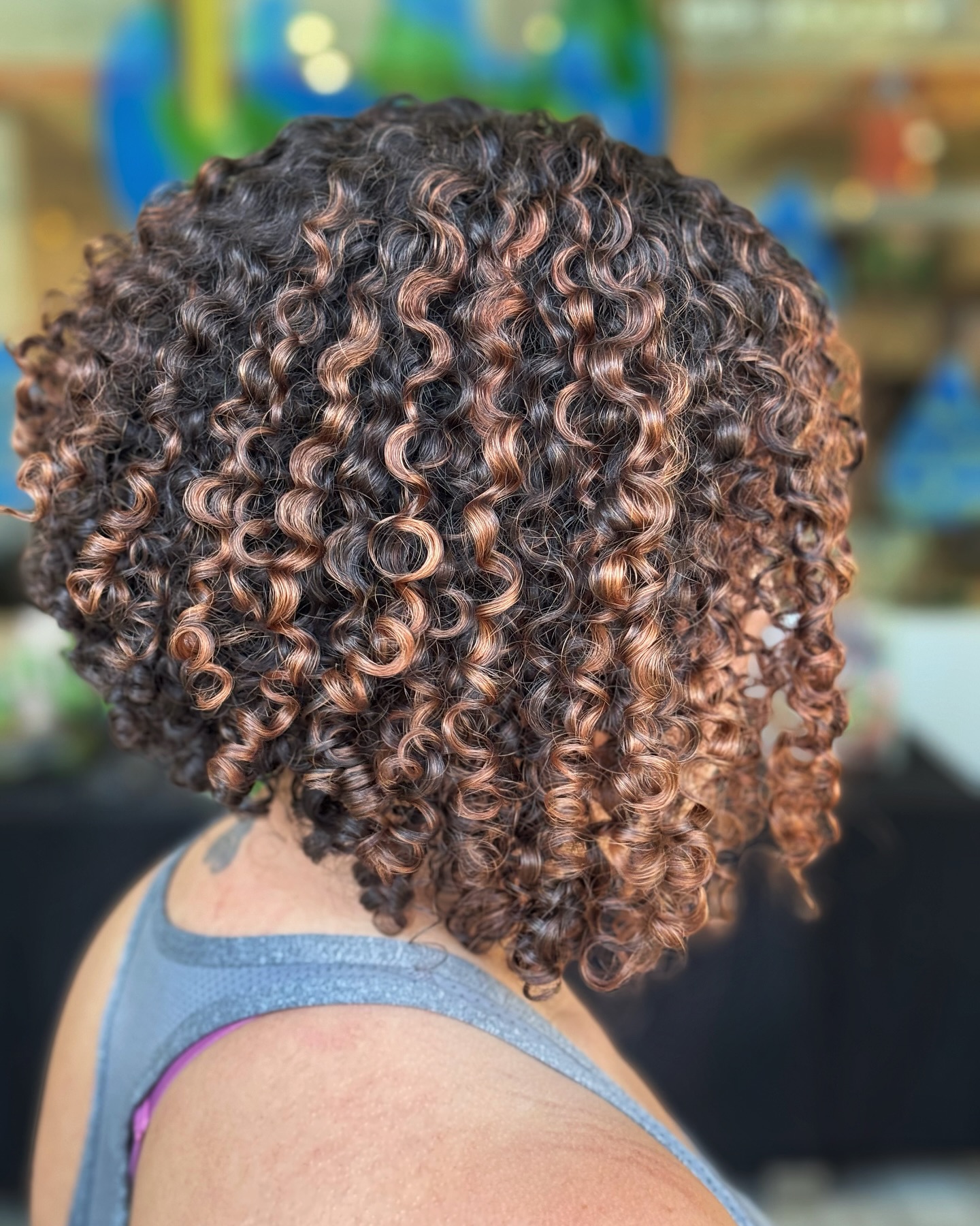 Charming Curly Bob with Warm Highlights