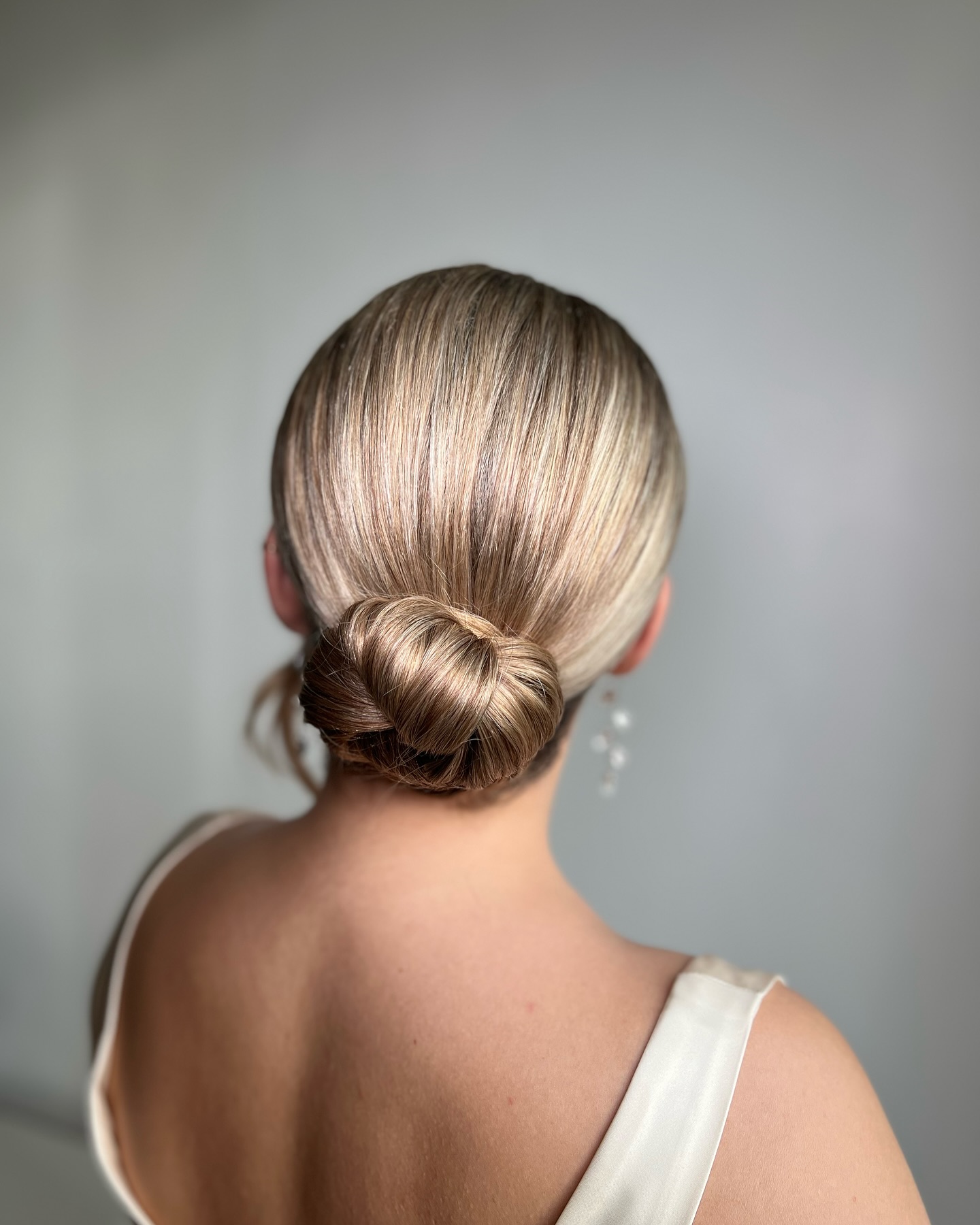 Elegant Twisted Low Bun with Glossy Finish