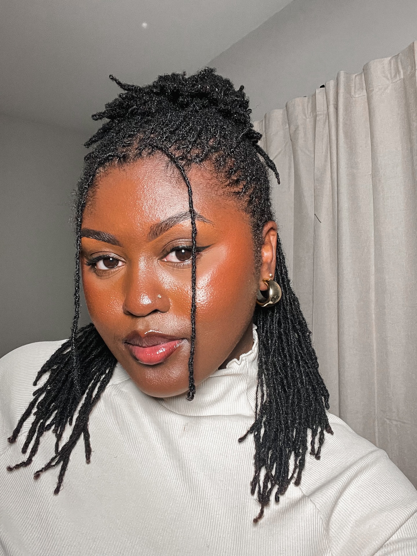 Chic High Bun Dreadlock Style with Face-Framing Strands