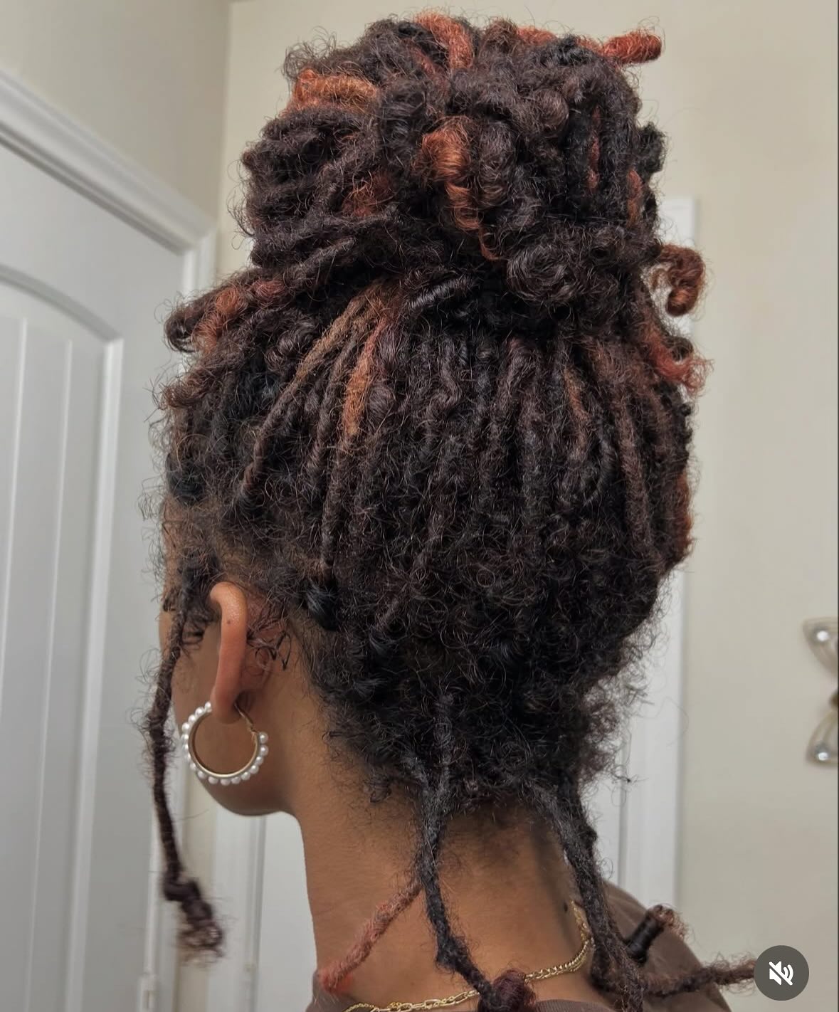 Elegant High Bun Dreadlock Style with Subtle Highlights