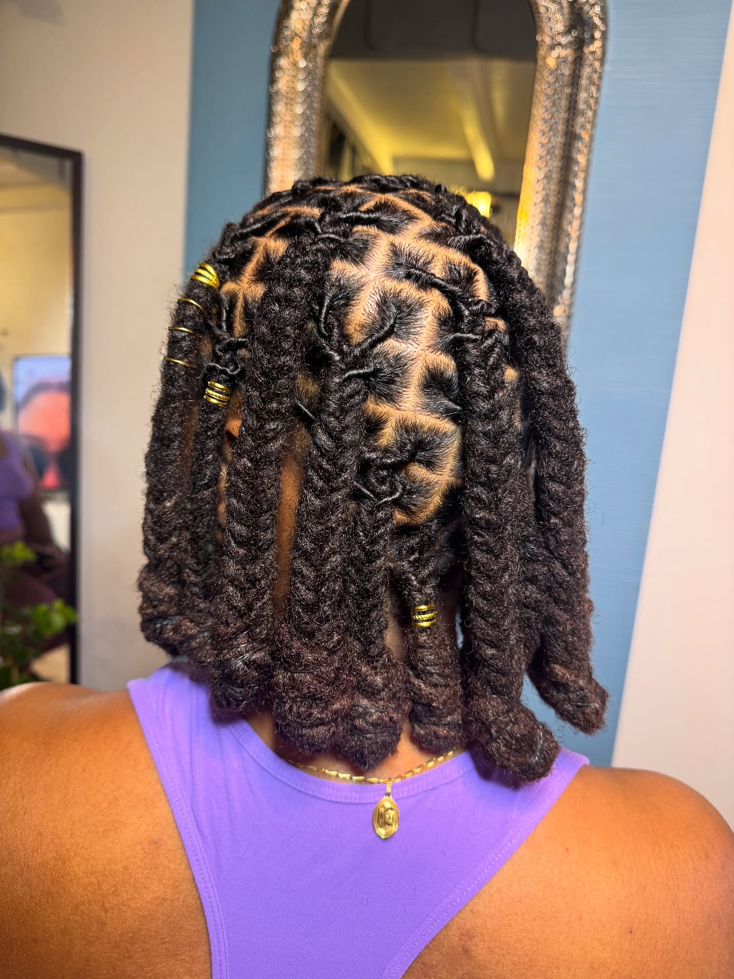 Intricate Twisted Dreadlock Style with Golden Accents