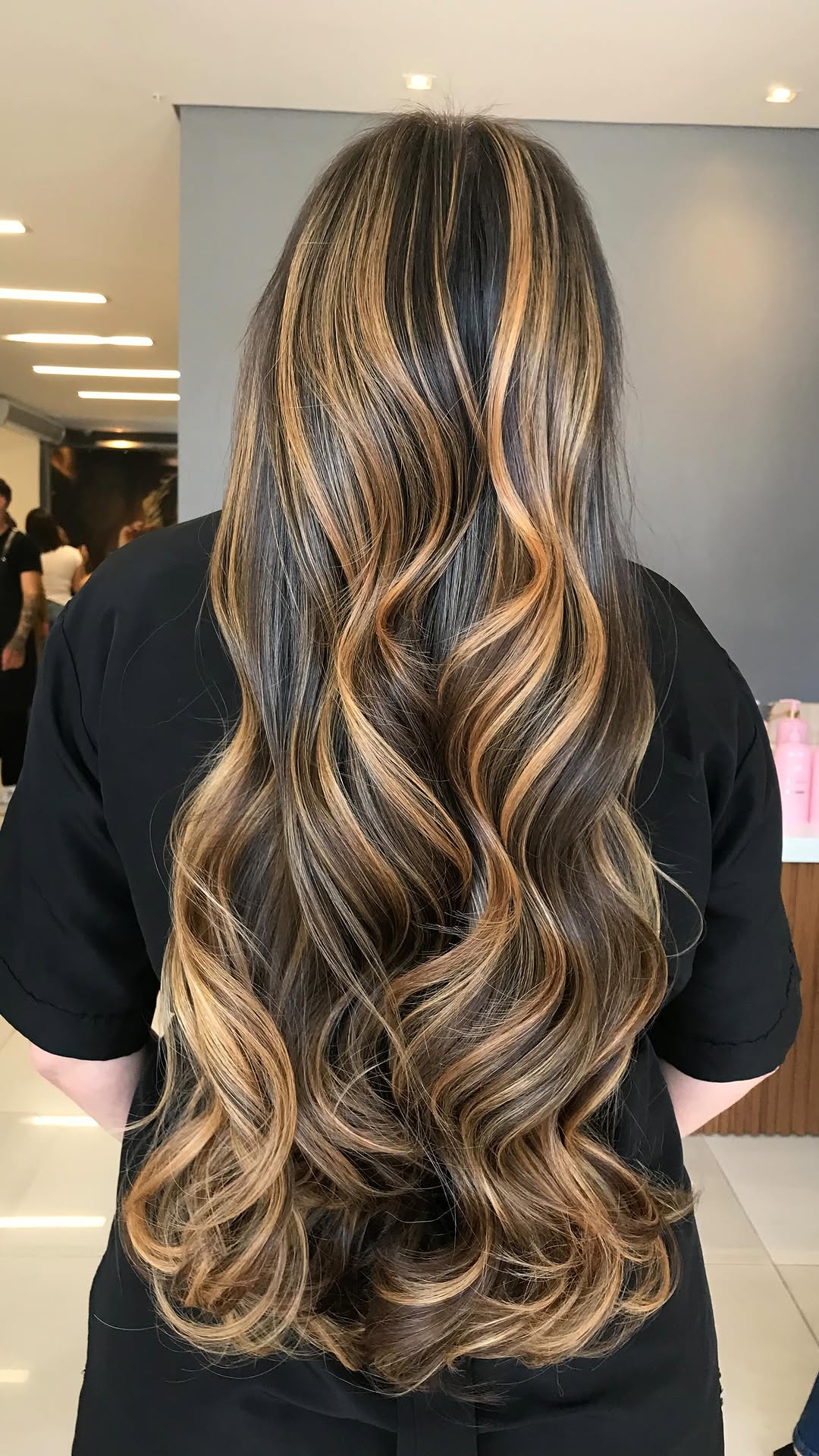 Radiant Brunette Waves with Golden Highlights