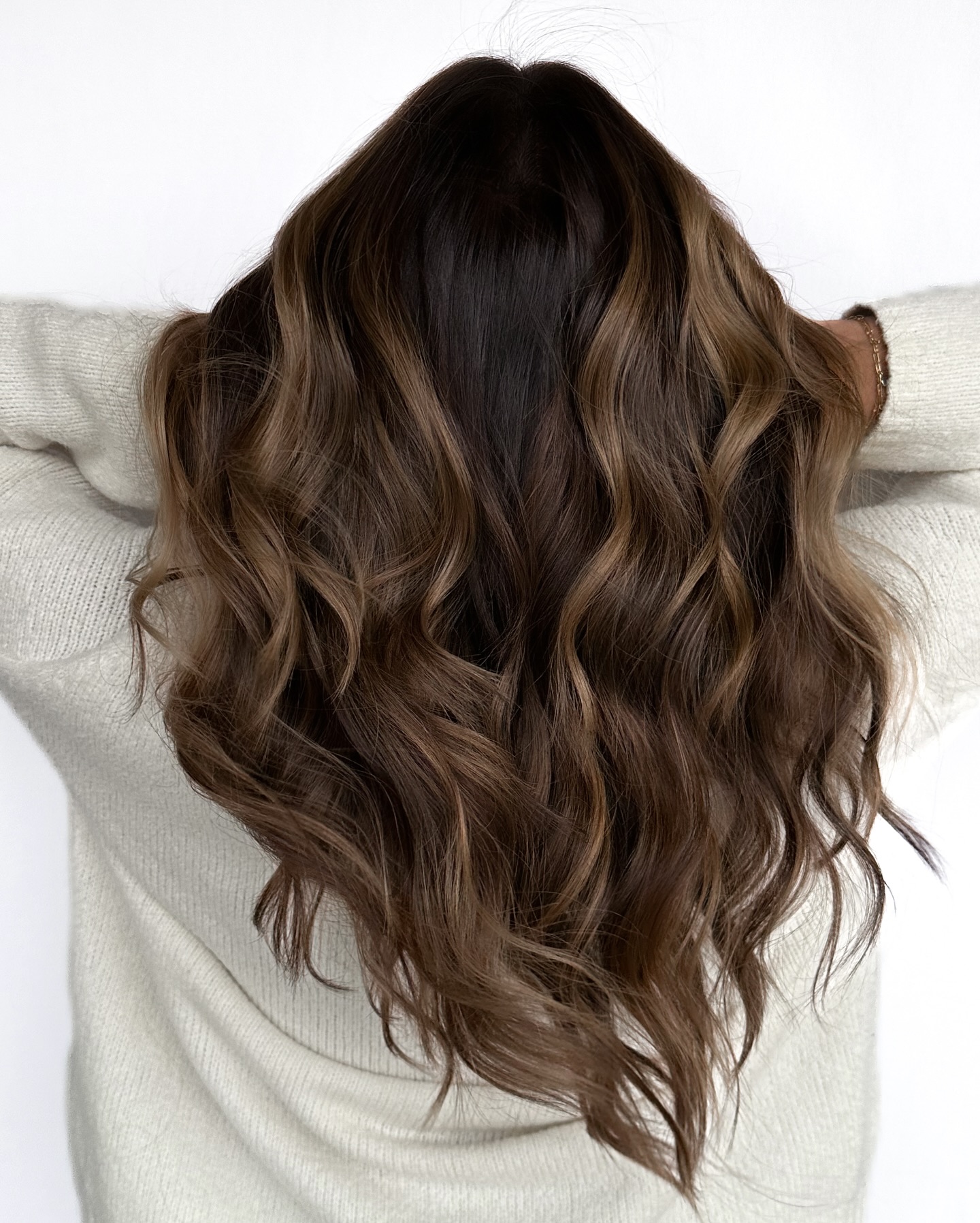 Soft Layered Brunette Waves with Sunlit Highlights