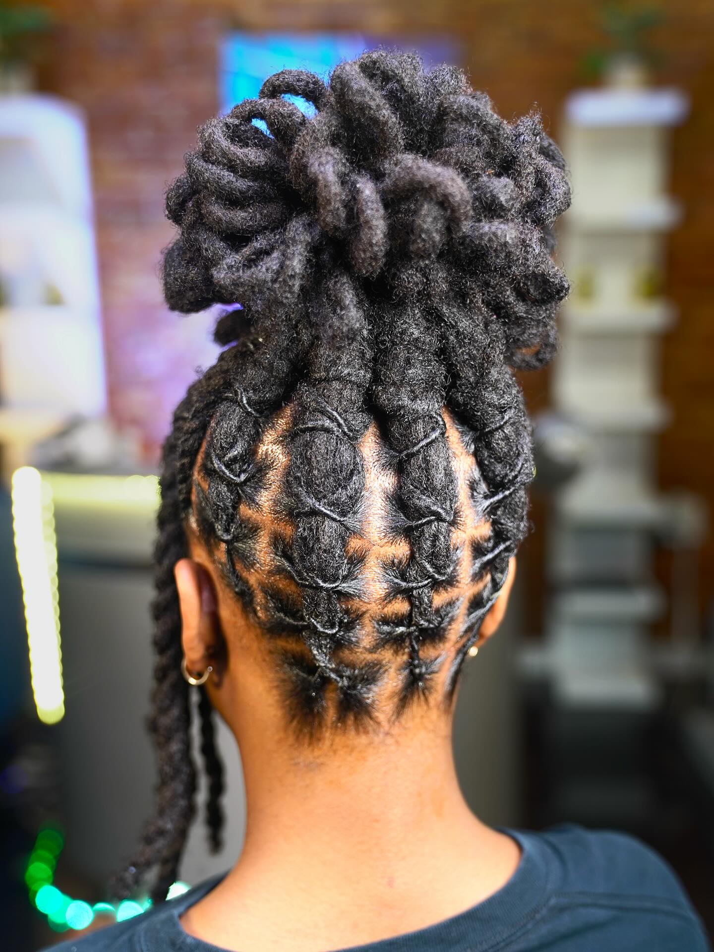 Textured High Bun Dreadlock Style with Braided Accents