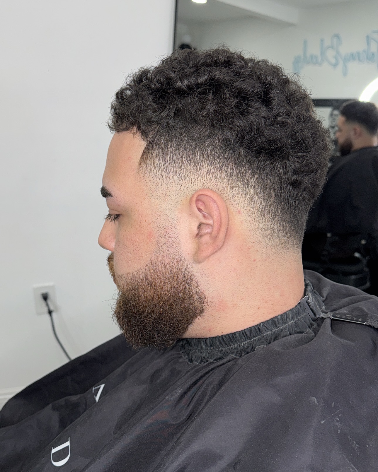Modern Mid Drop Fade with Curly Top and Defined Beard