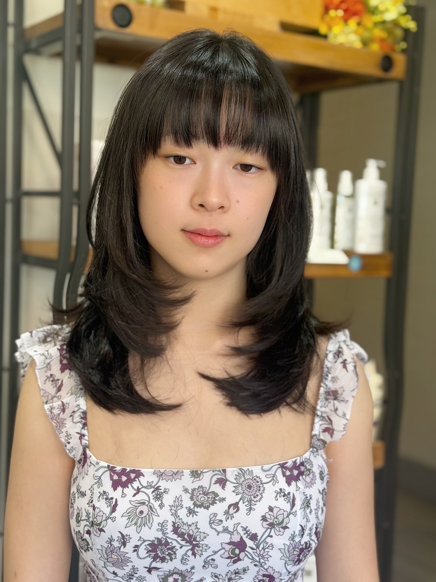 Chic Ebony Layered Cut with Wispy Bangs