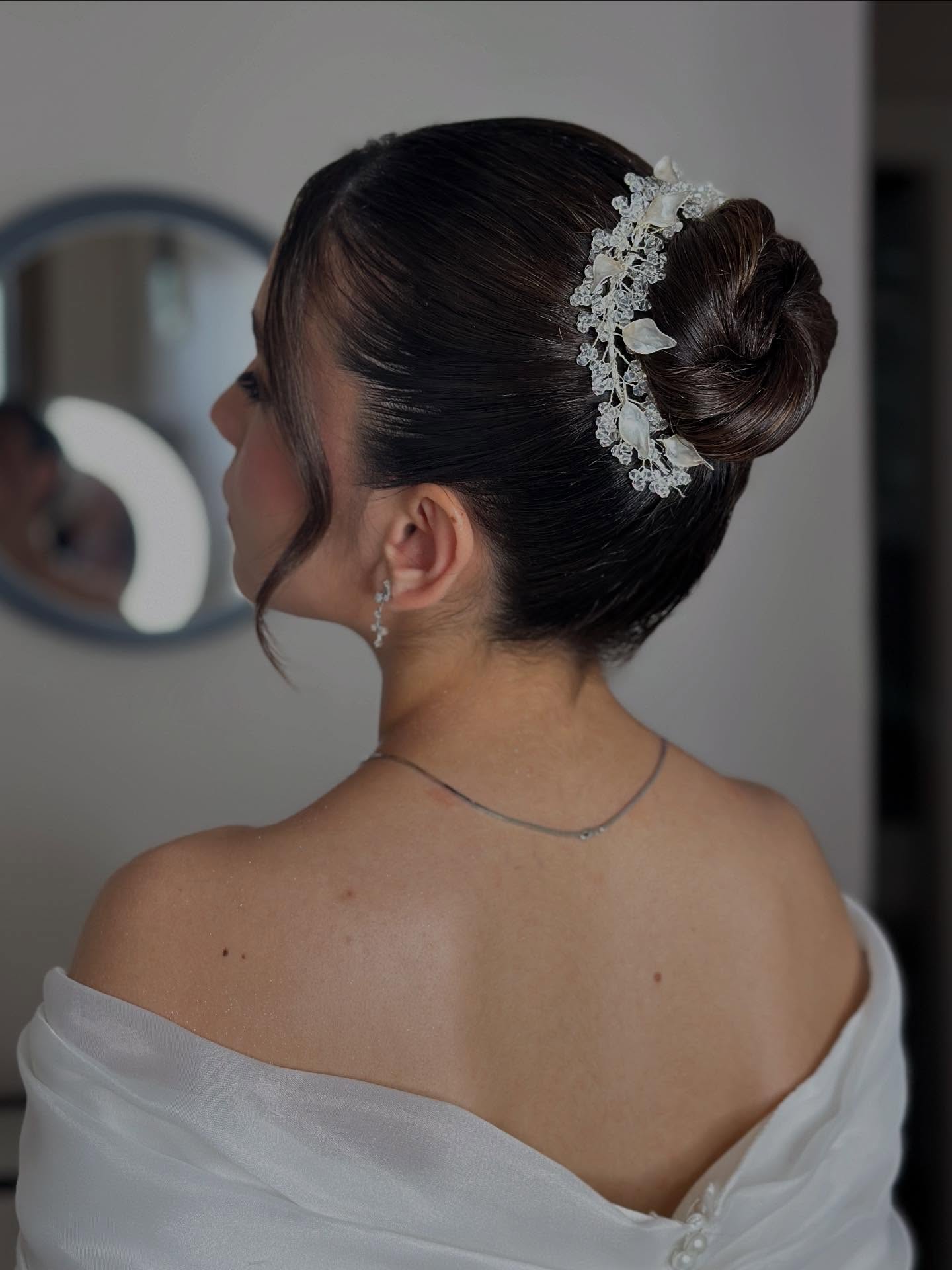 Elegant Twisted Low Bun with Floral Accents