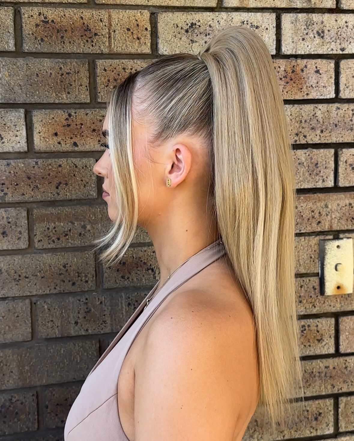 Sleek High Ponytail with Face-Framing Pieces
