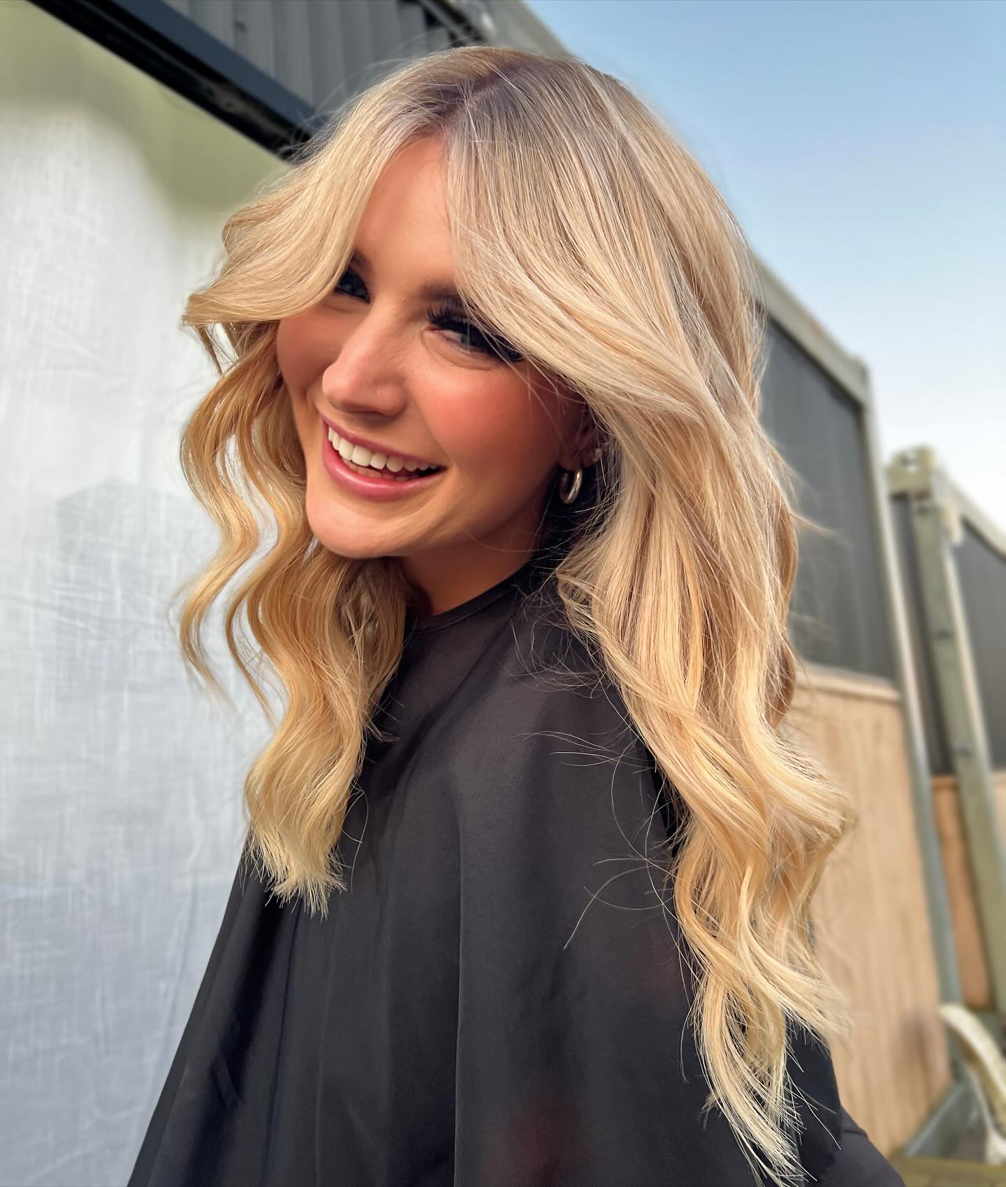 Effortlessly Voluminous Blonde Waves with Face-Framing Layers