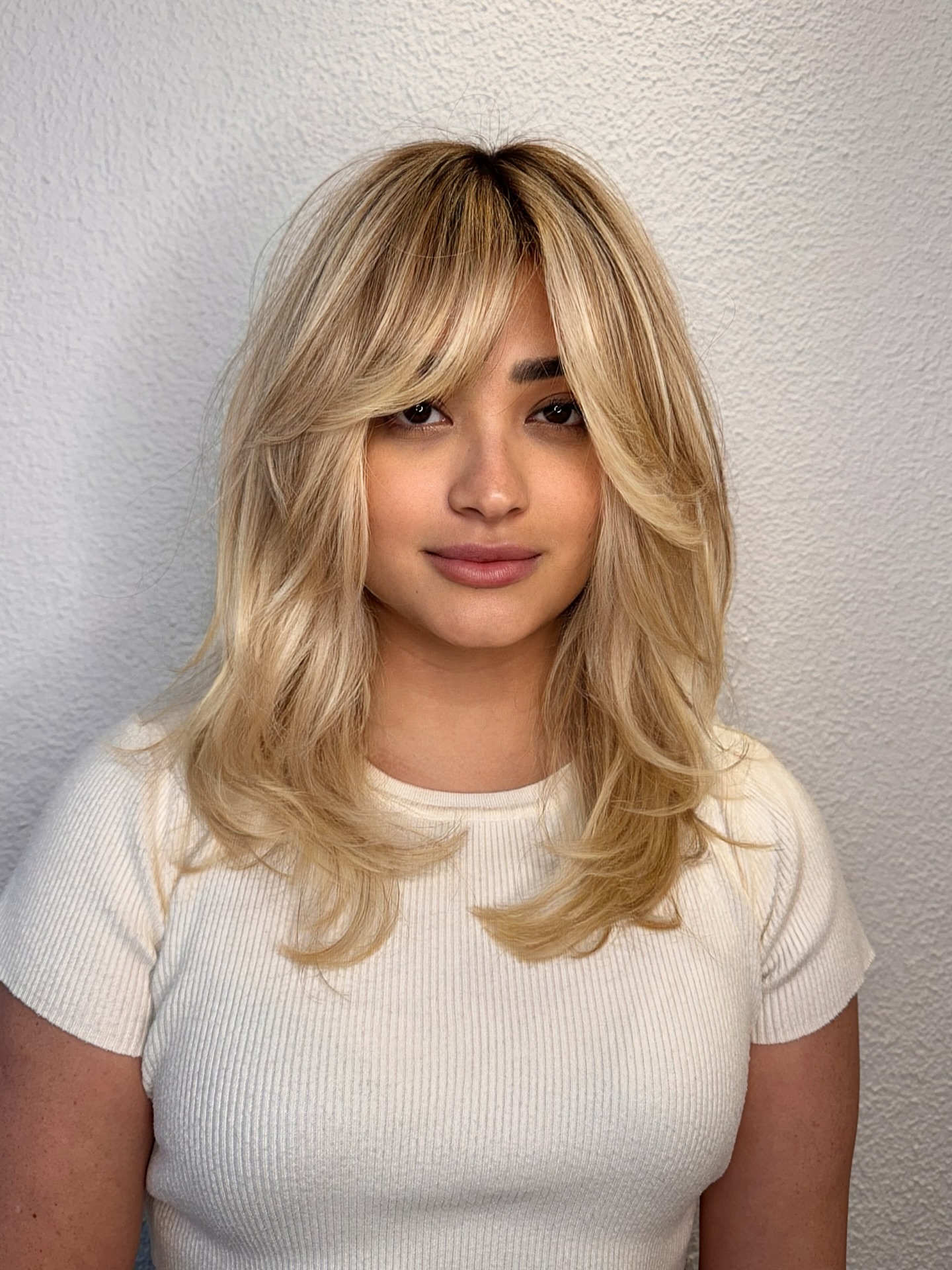 Soft Blonde Layered Shag with Face-Framing Bangs