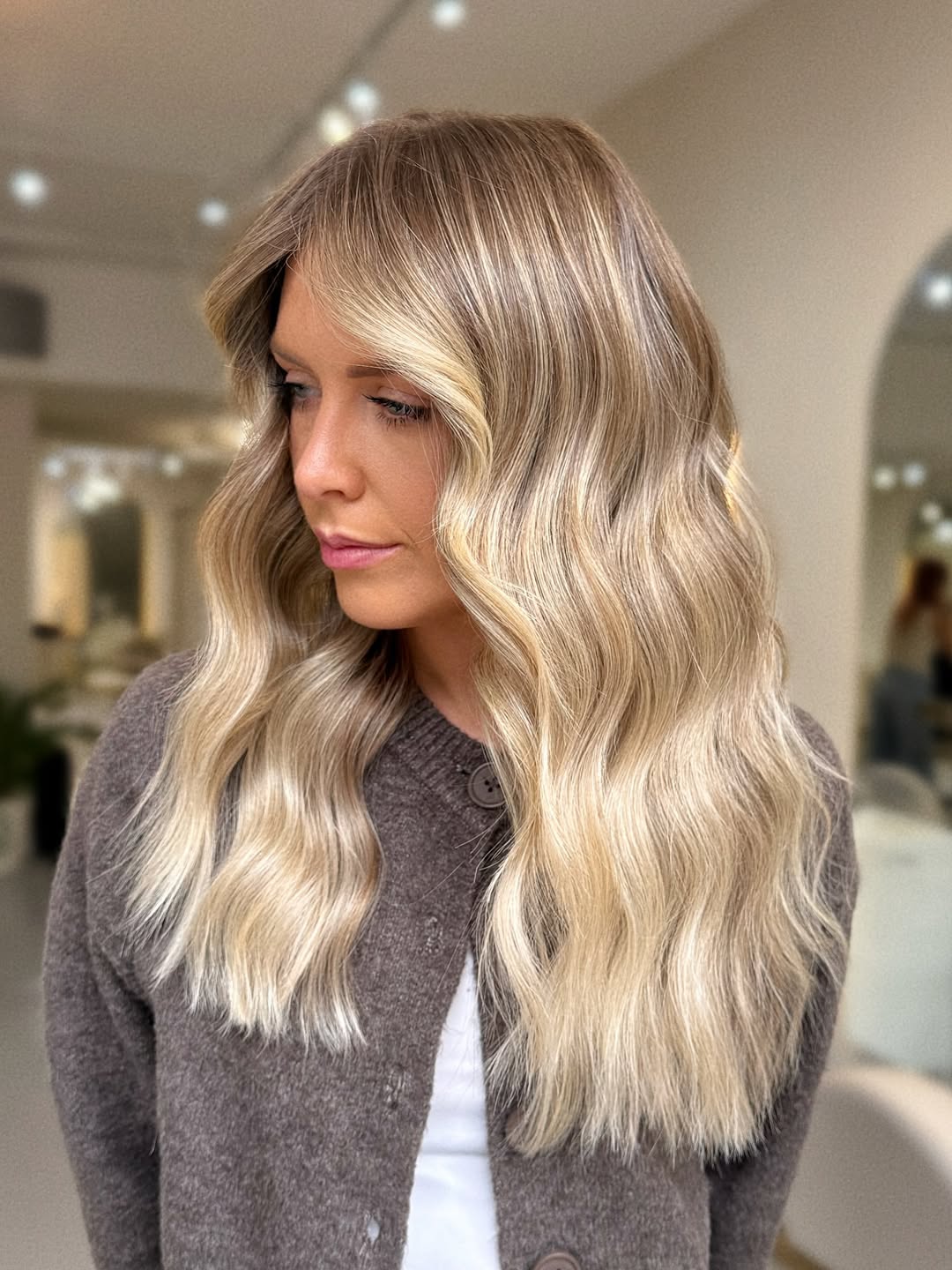 Radiant Soft Root Melt Blonde Balayage with Glossy Waves