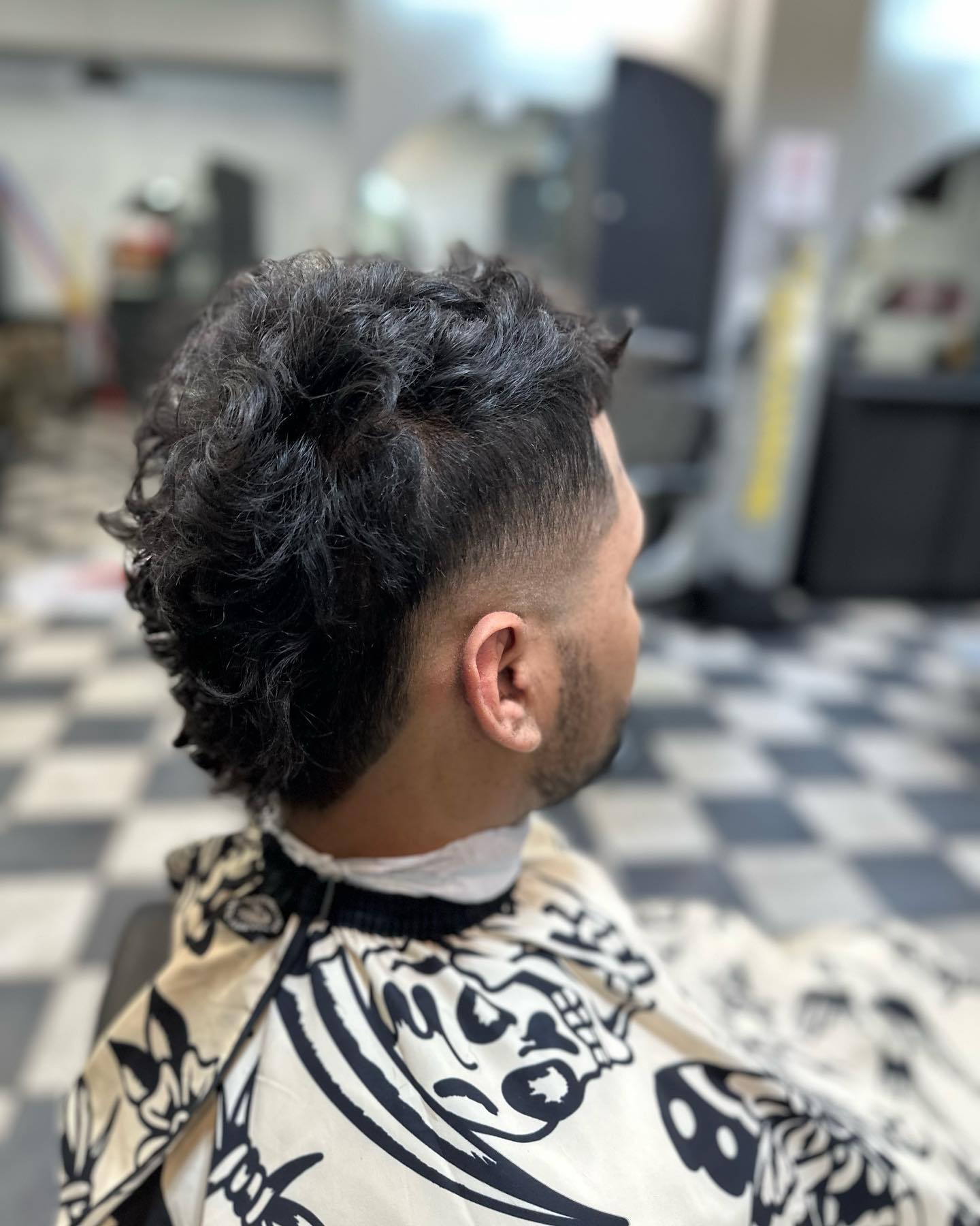Textured Burst Fade Mohawk with Defined Curls