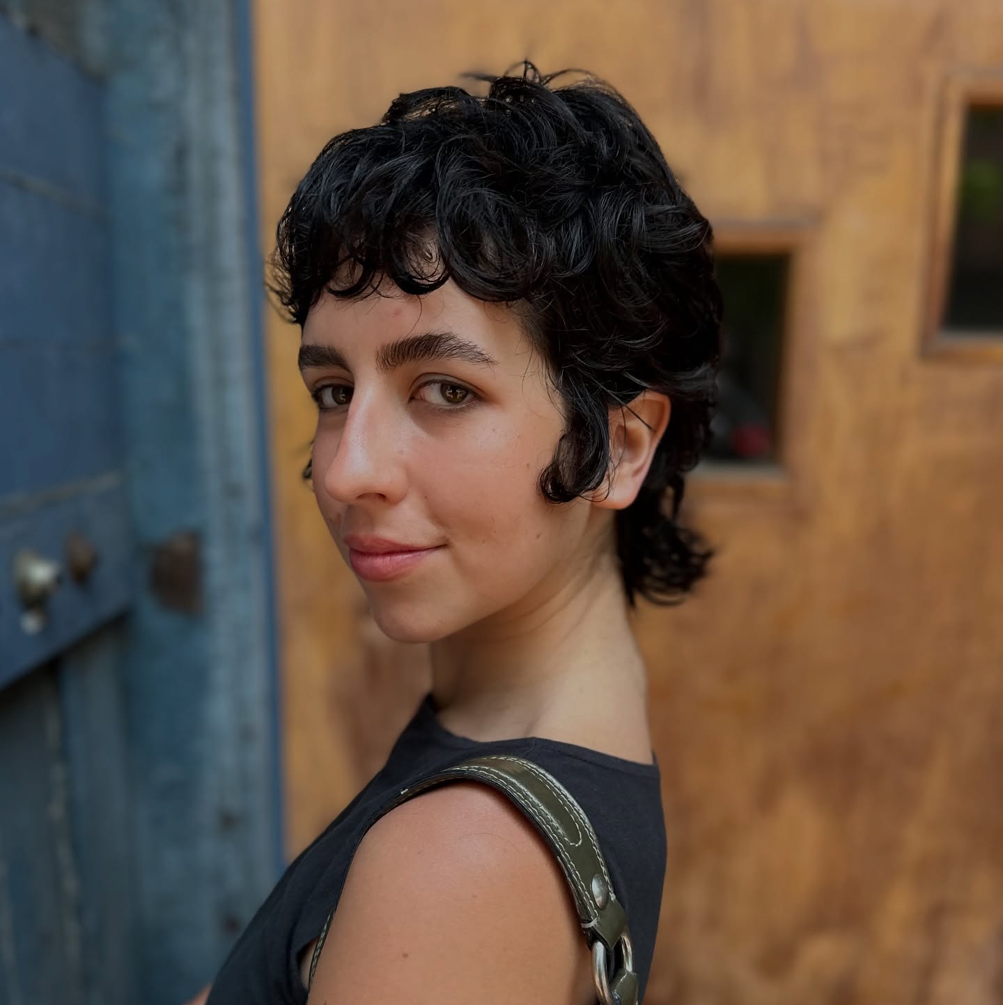 Sultry Black Curled Pixie with Natural Volume