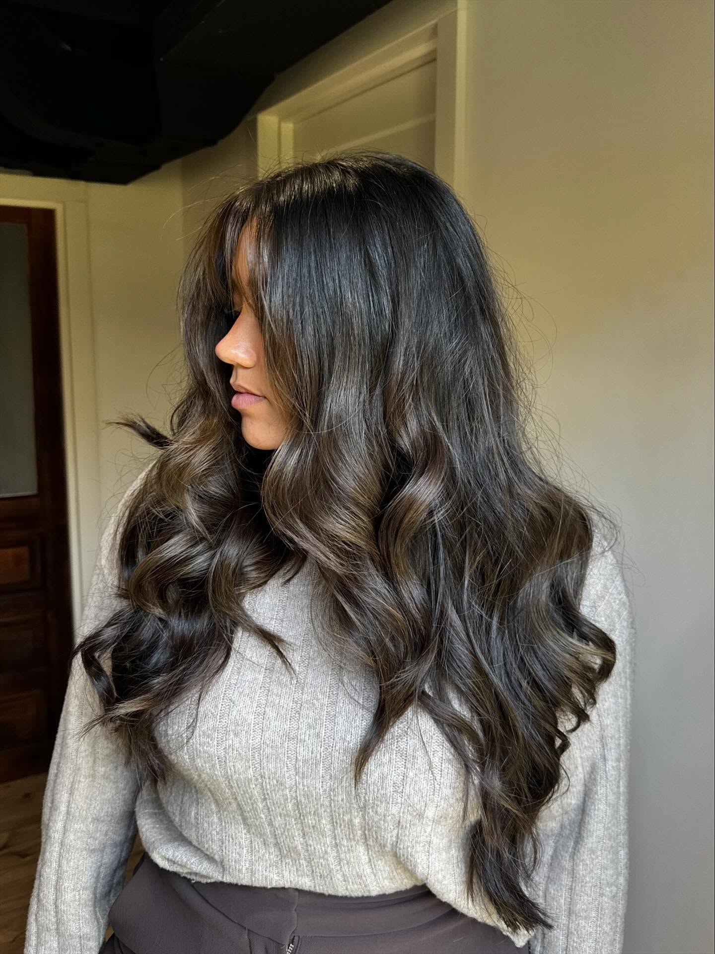 Voluminous Brunette Curls with Subtle Highlights