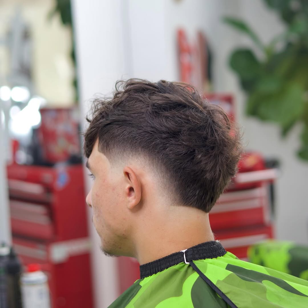 Trendy Textured Burst Fade Mohawk with Defined Curls