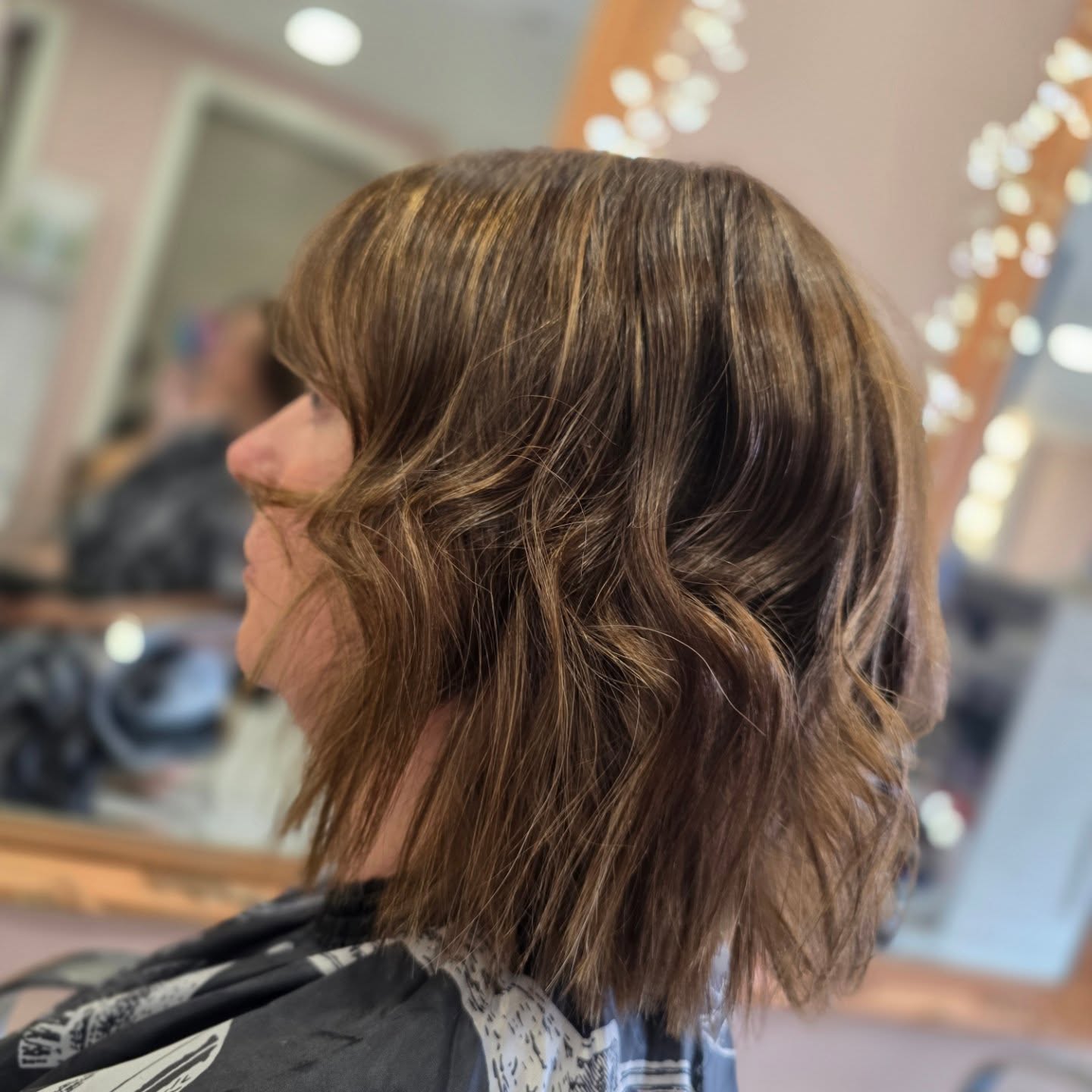 Choppy Soft-Textured Collarbone Bob with Side-Swept Fringe and Subtle Babylights