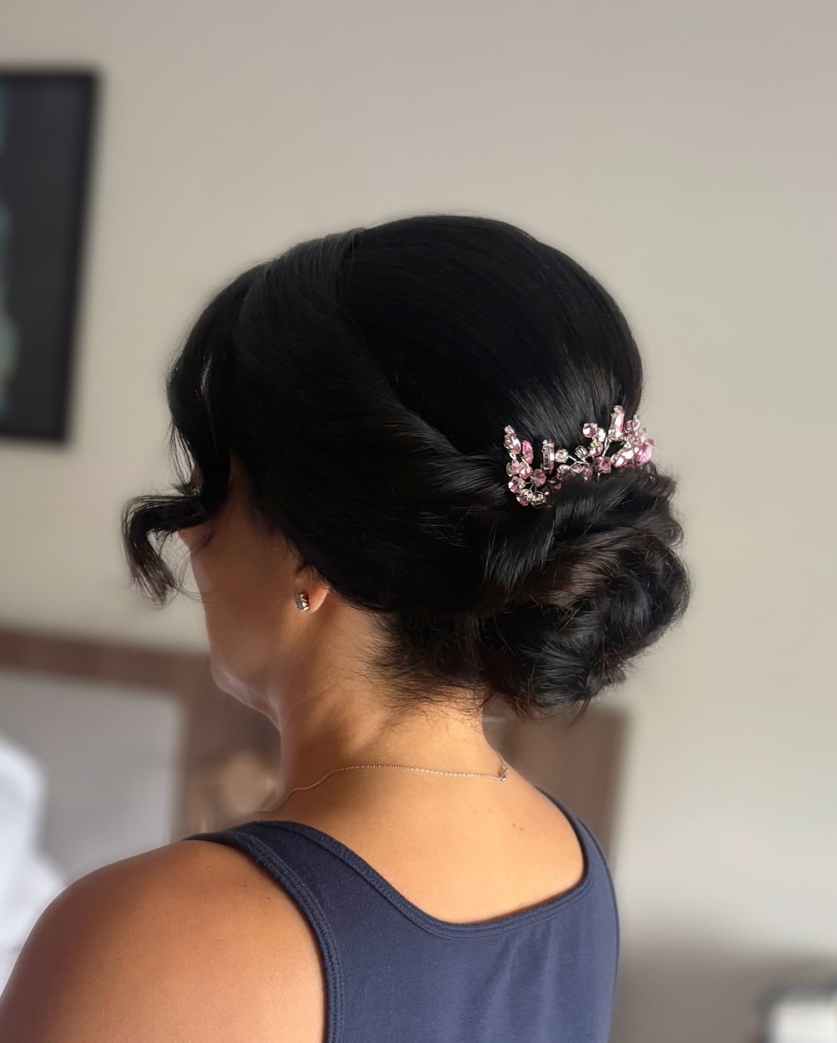 Glossy Low Twisted Chignon with Pink Crystal Accent