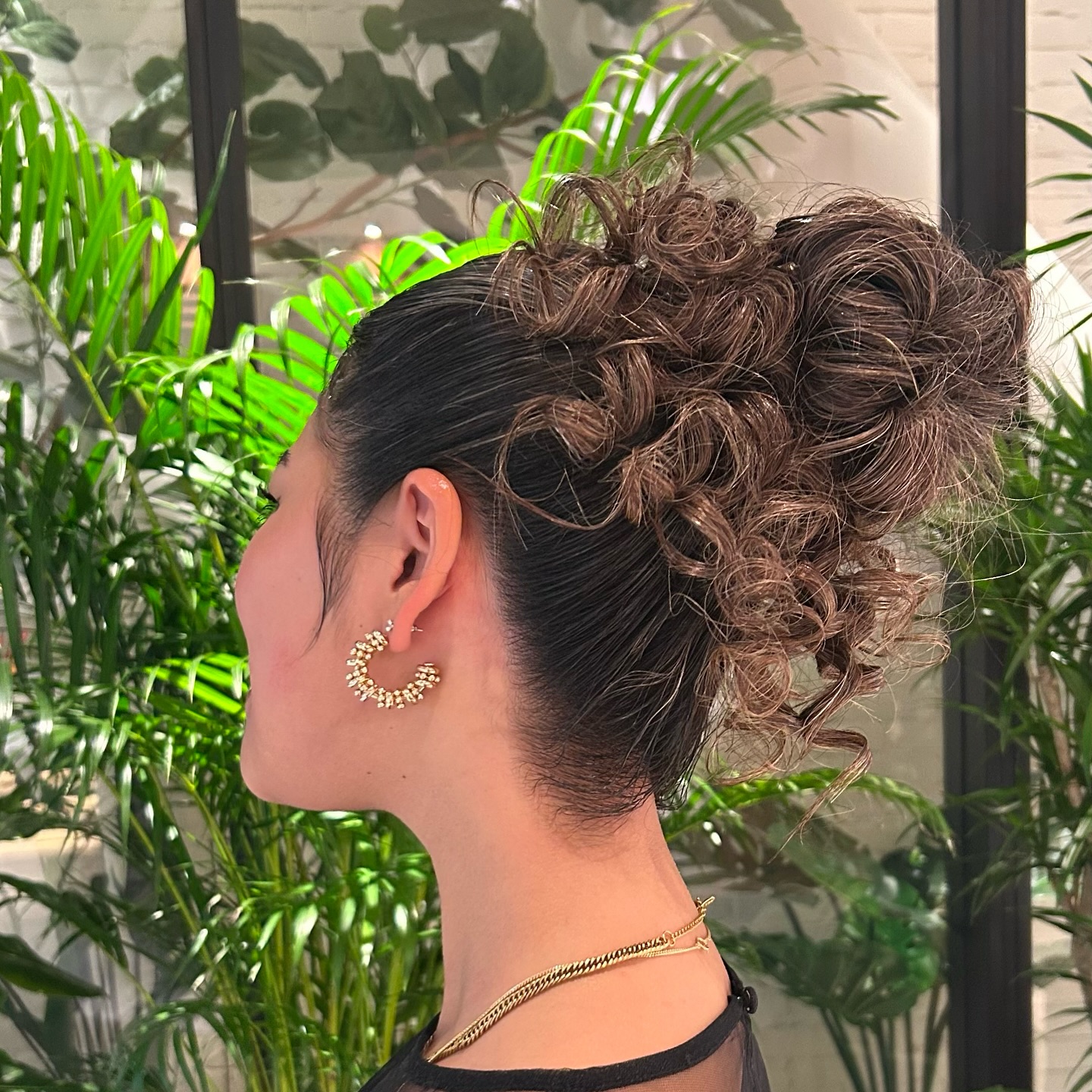 Glossy Slicked Sides with Voluminous Curly High Bun