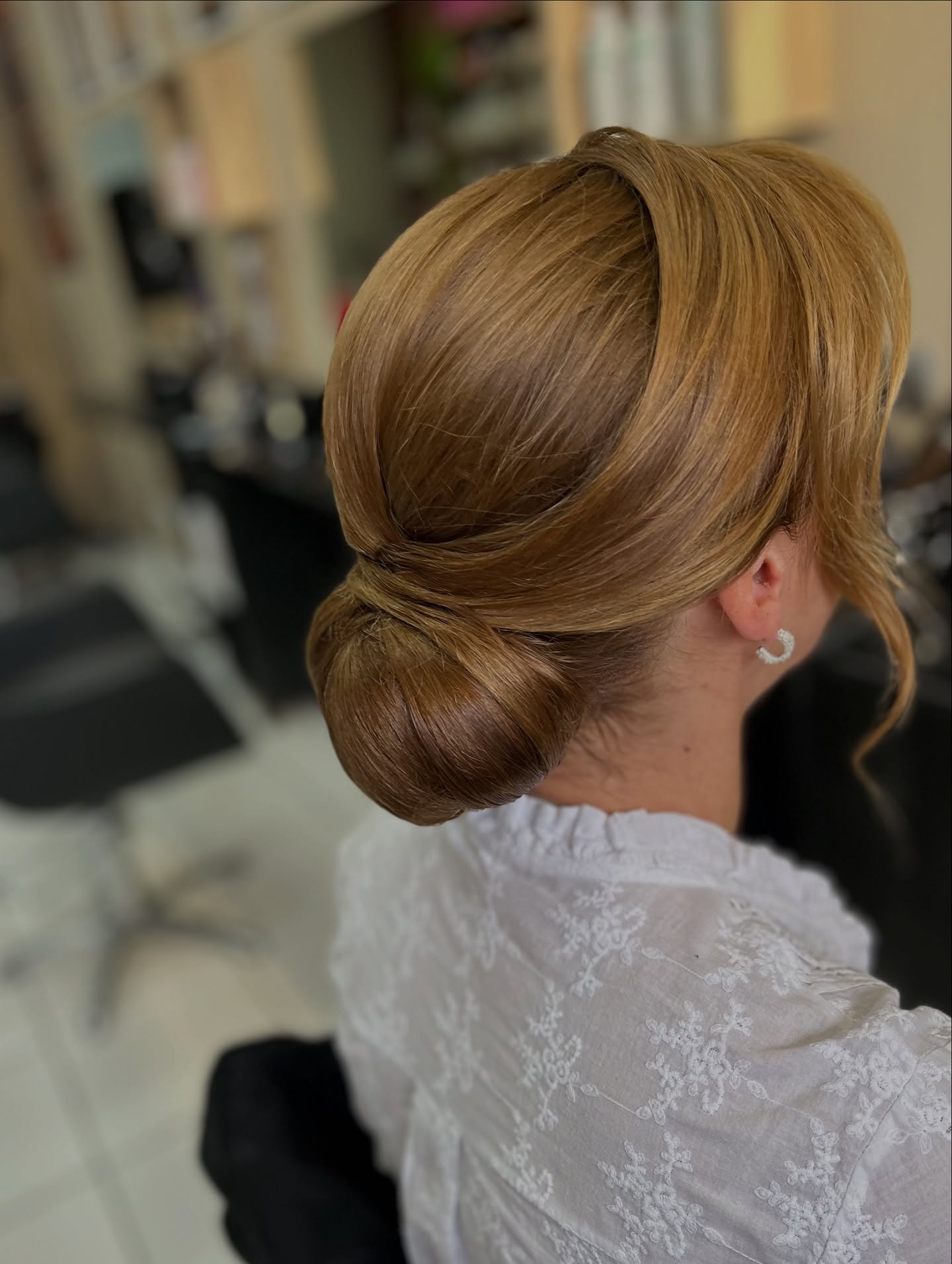 Polished Low Rolled Chignon with Sculpted Side Swoop