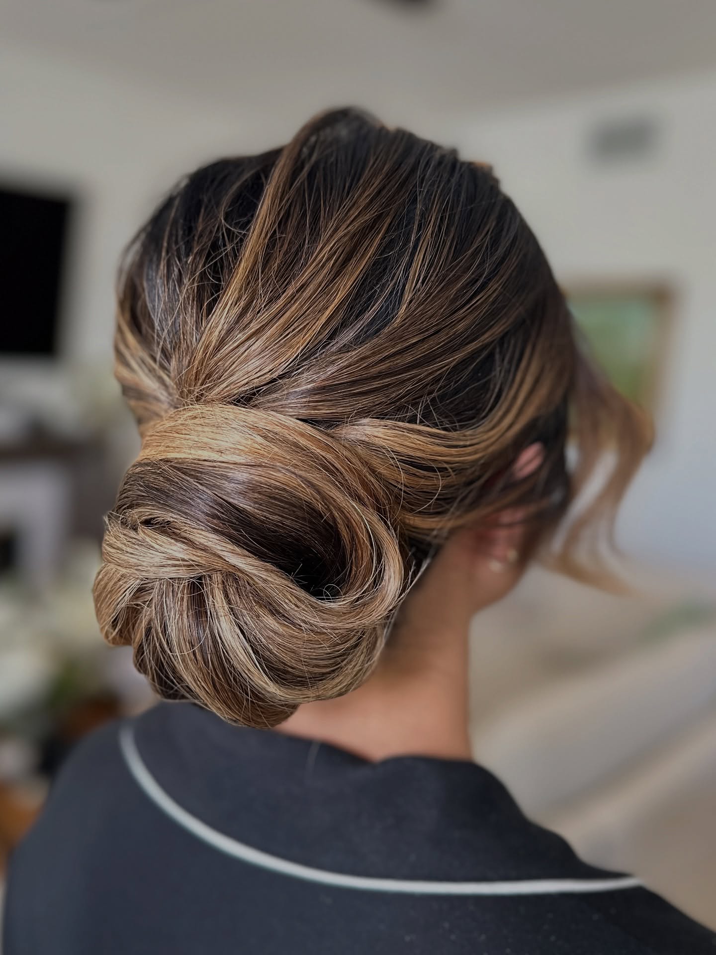 Polished Wrapped Low Chignon with Warm Balayage Accents