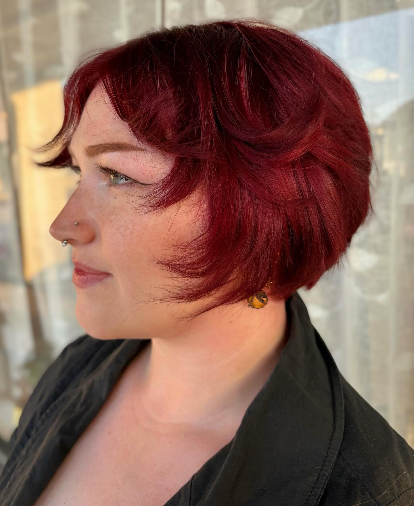 Ruby Red Short Stacked Bob with Feathered Face-Framing Flips