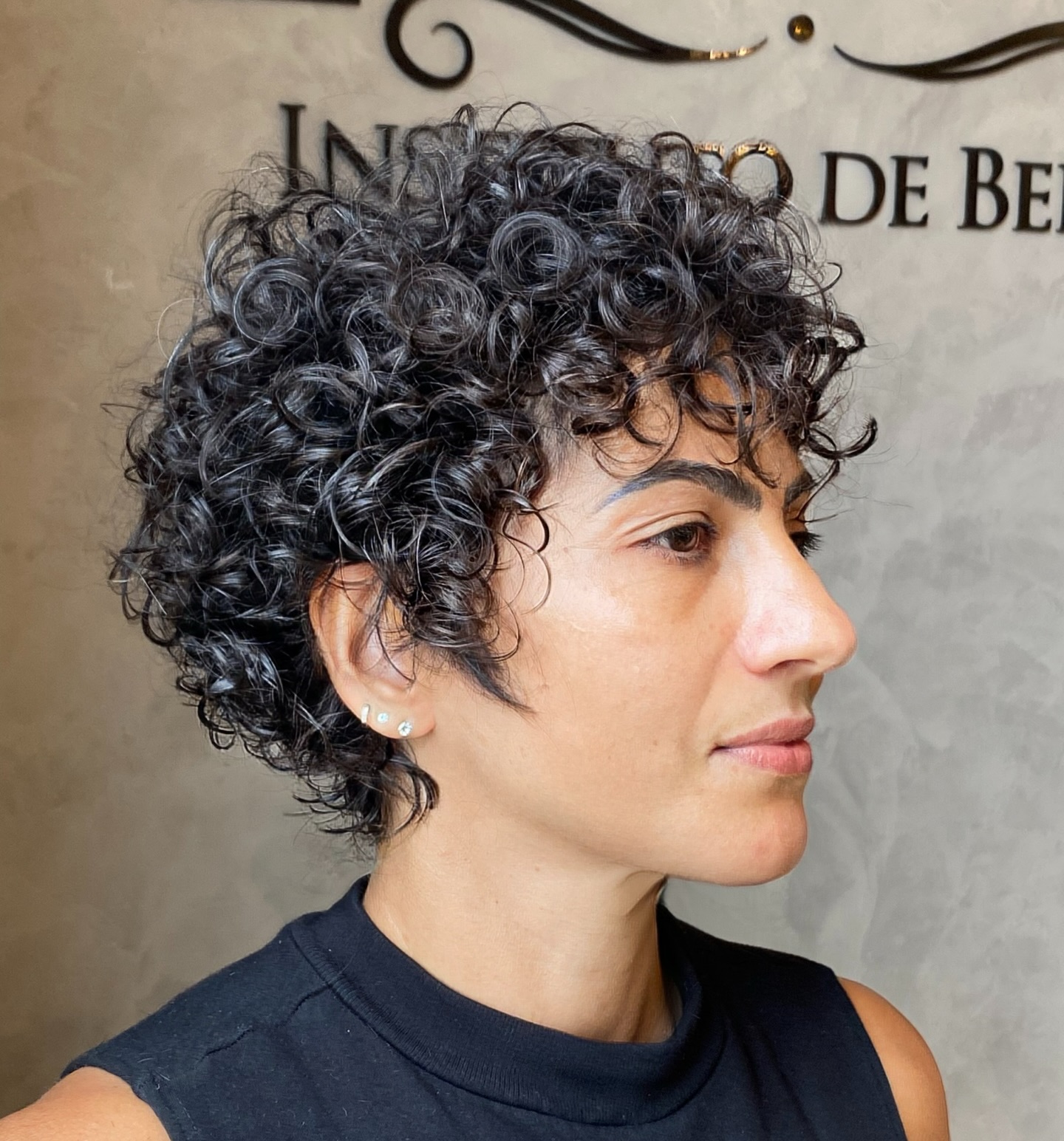 Short Curly Pixie with Tapered Nape and Face-Framing Tendrils
