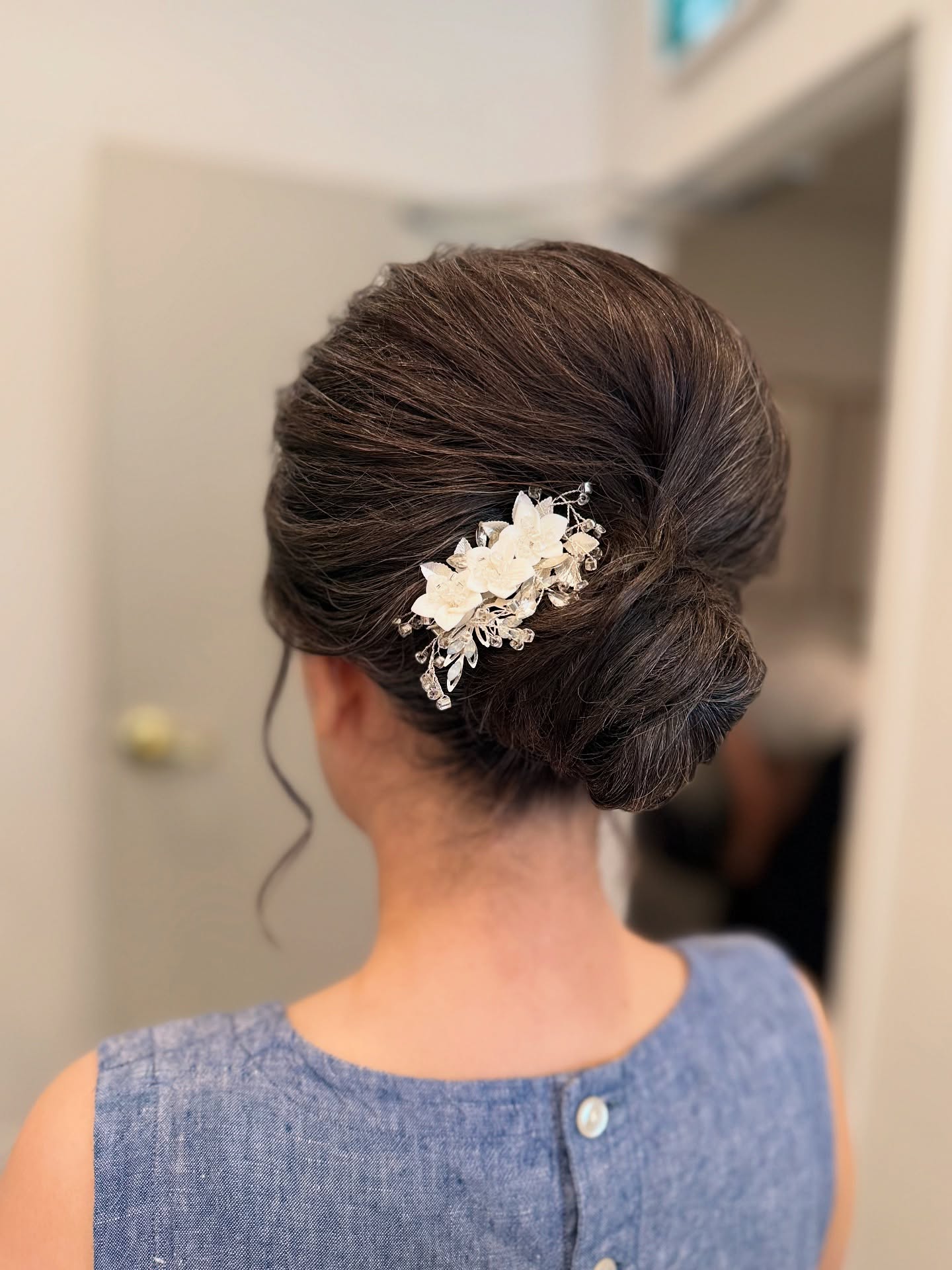 Sleek Low Rolled Chignon with Floral Crystal Comb