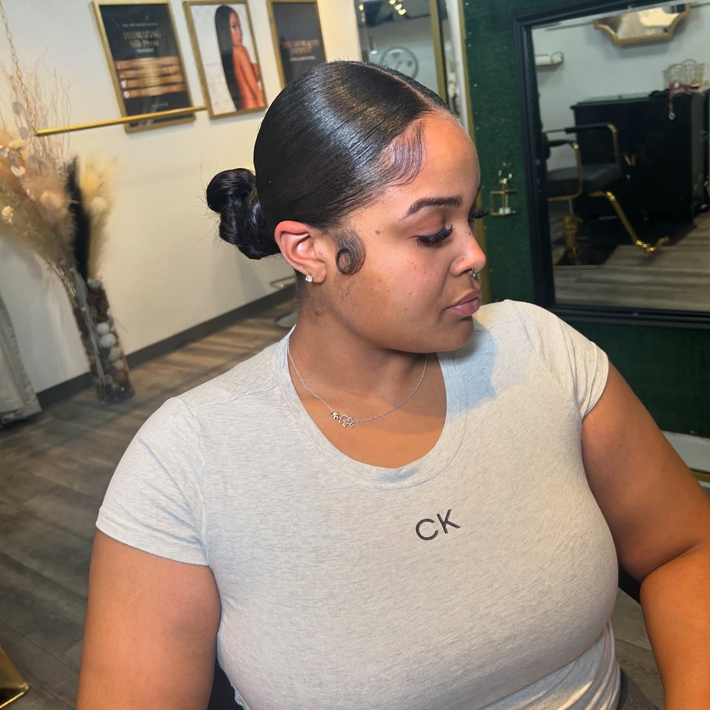 Sleek Low Twisted Bun with Sculpted Baby Hairs