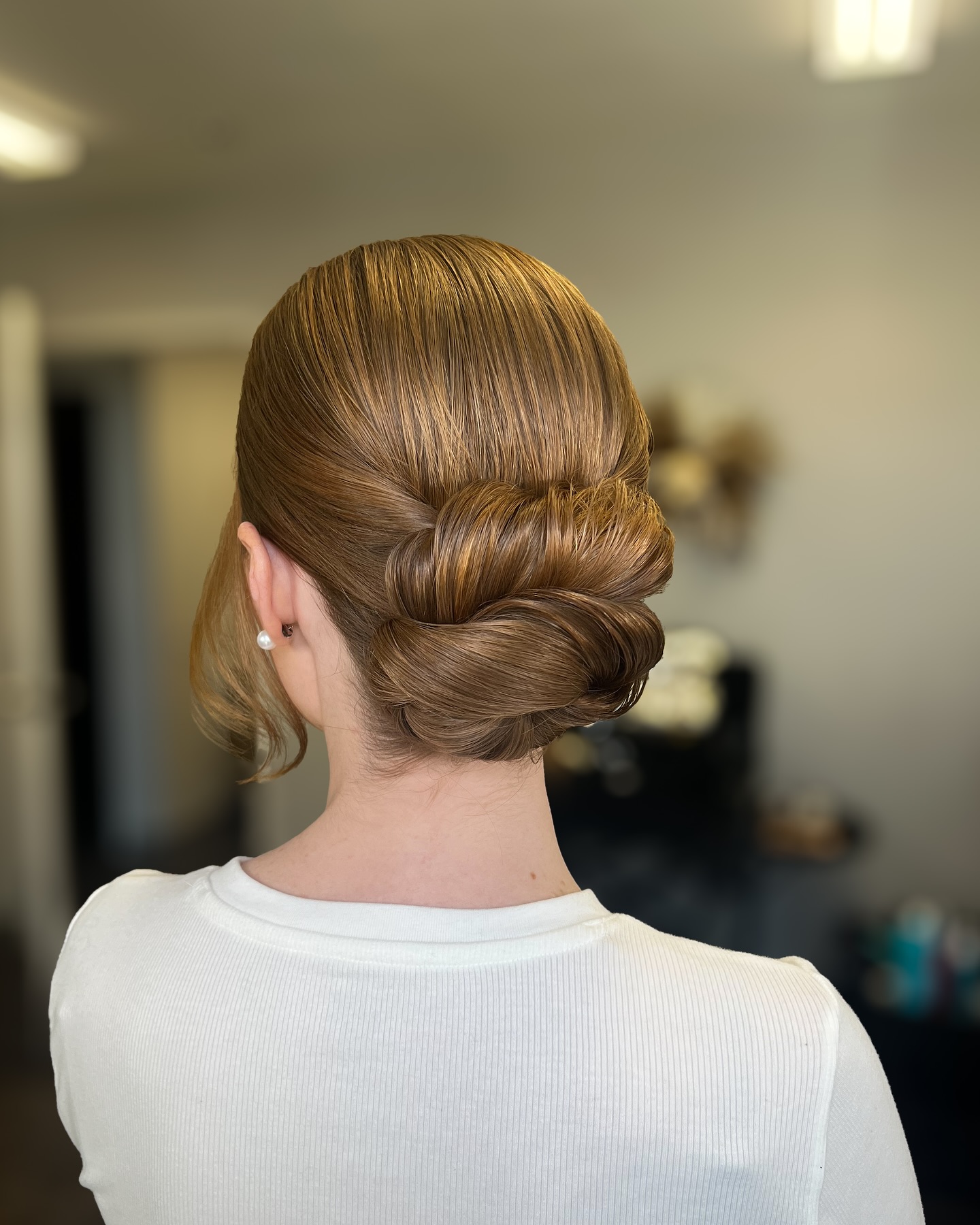 Sleek Rolled Low Chignon with Face-Framing Tendril