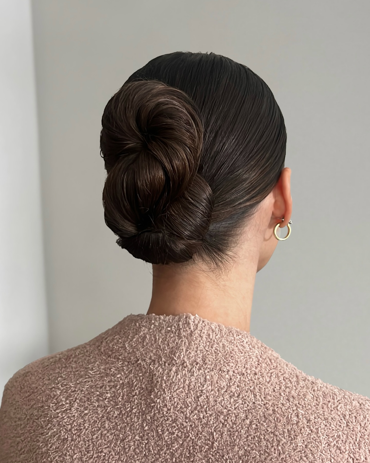 Sleek Stacked Coiled Low Bun with Glossy Brown Finish