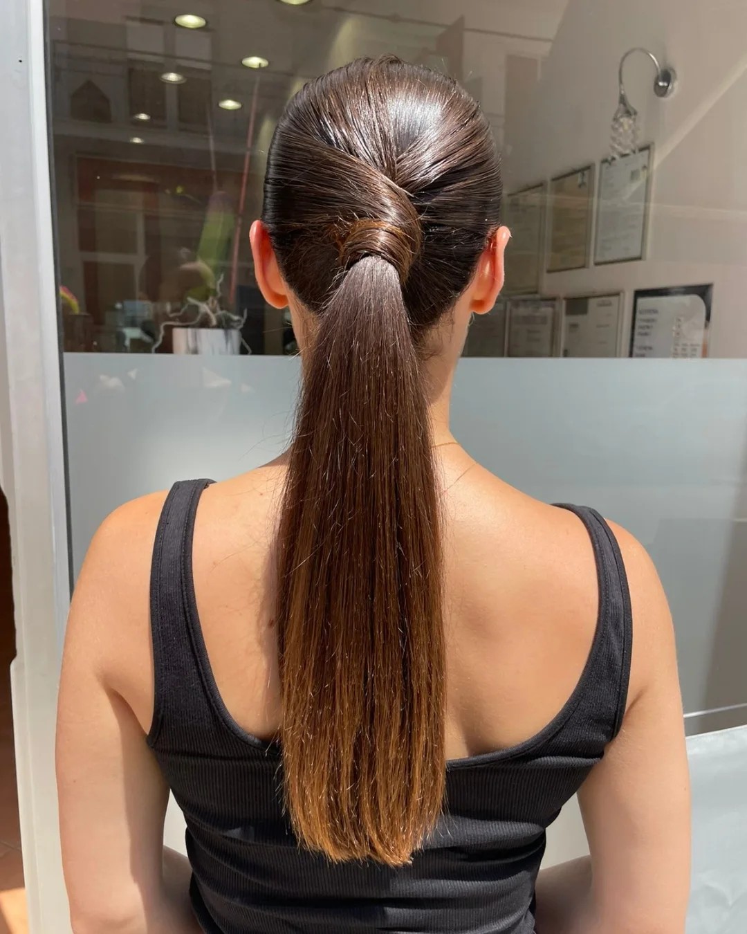 Sleek Wrapped Low Ponytail with Subtle Caramel Balayage