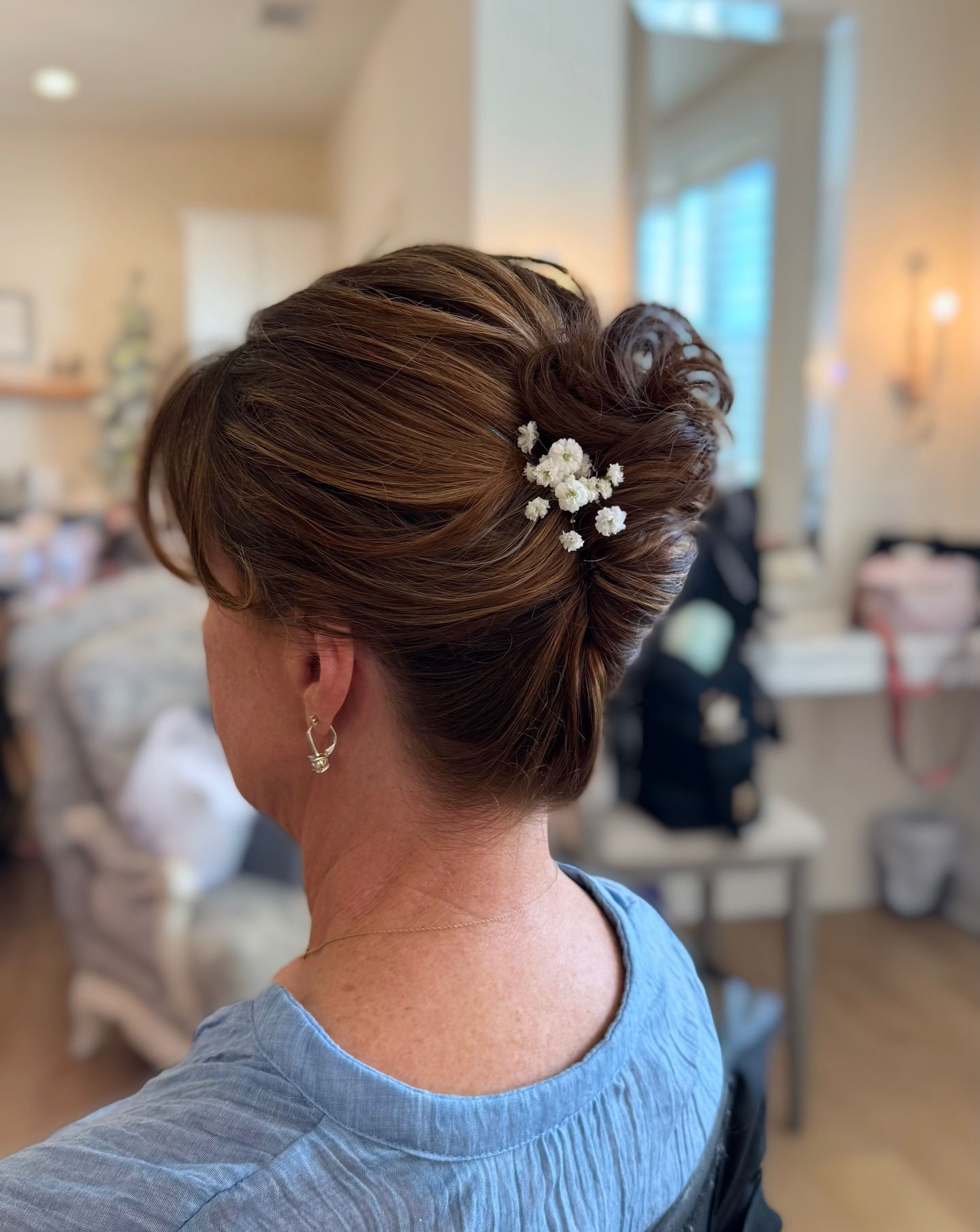 Soft Caramel French Twist with Tapered Nape and Baby's-Breath Pins