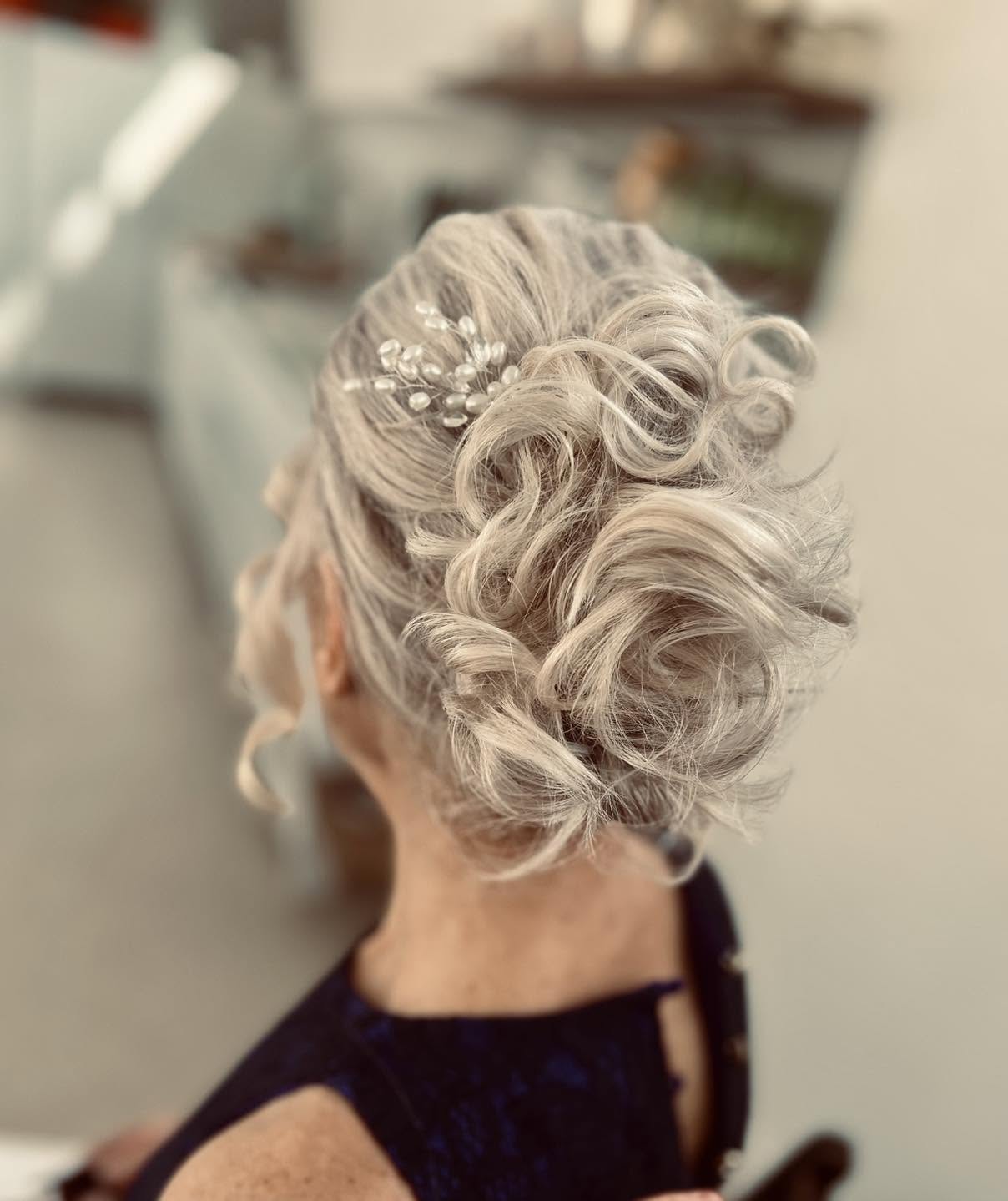 Soft Platinum Curled Low Chignon with Pearl Accent
