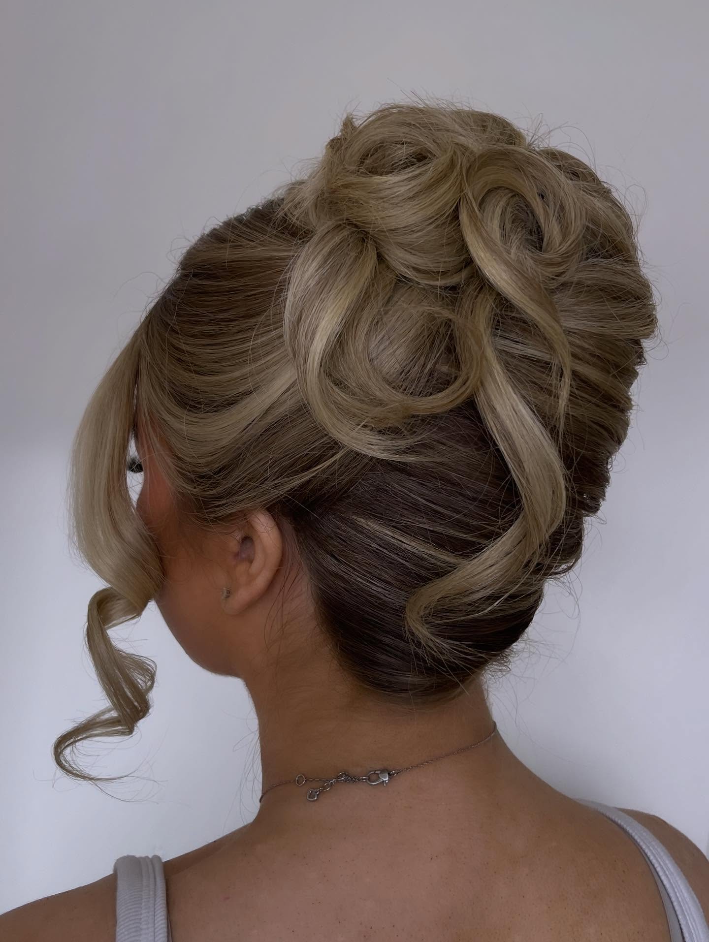 Soft Twisted Updo with Balayage Face-Framing Tendril