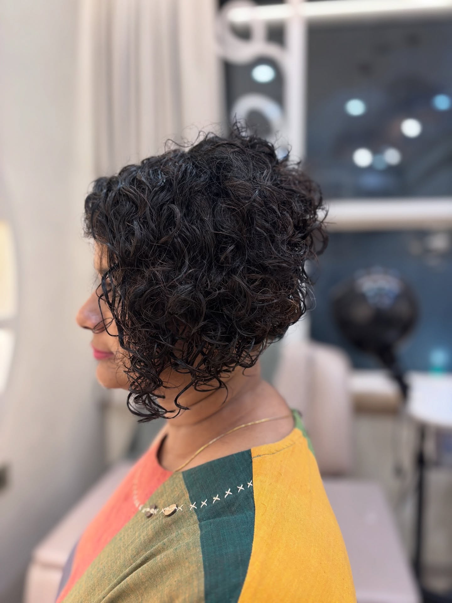 Stacked Chin-Length Curly Bob with Defined Clump Layers