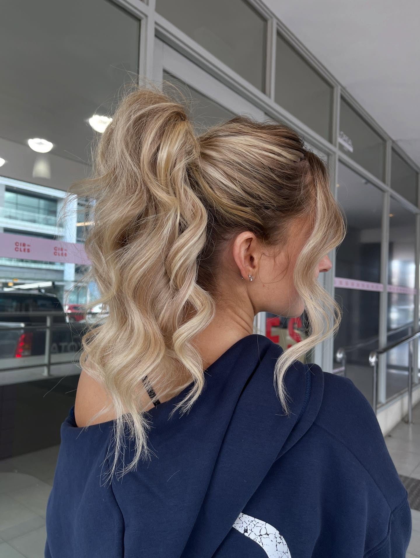 Textured Blonde Wrapped High Ponytail with Face-Framing Tendrils