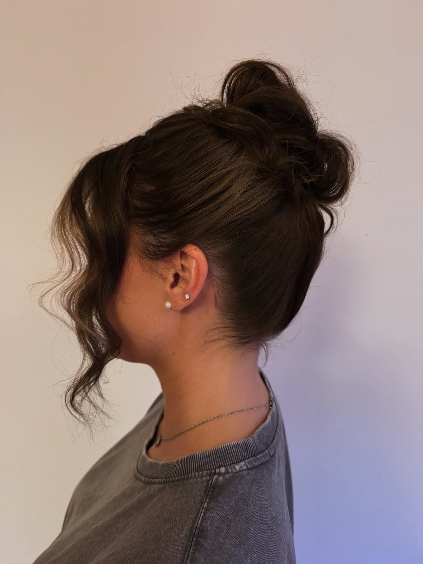 Textured High Bun with Spiral Face-Framing Tendril
