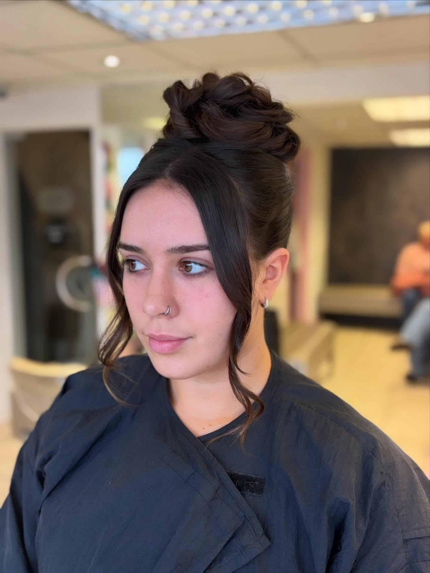 High Twisted Textured Bun with Center Curtain Tendrils