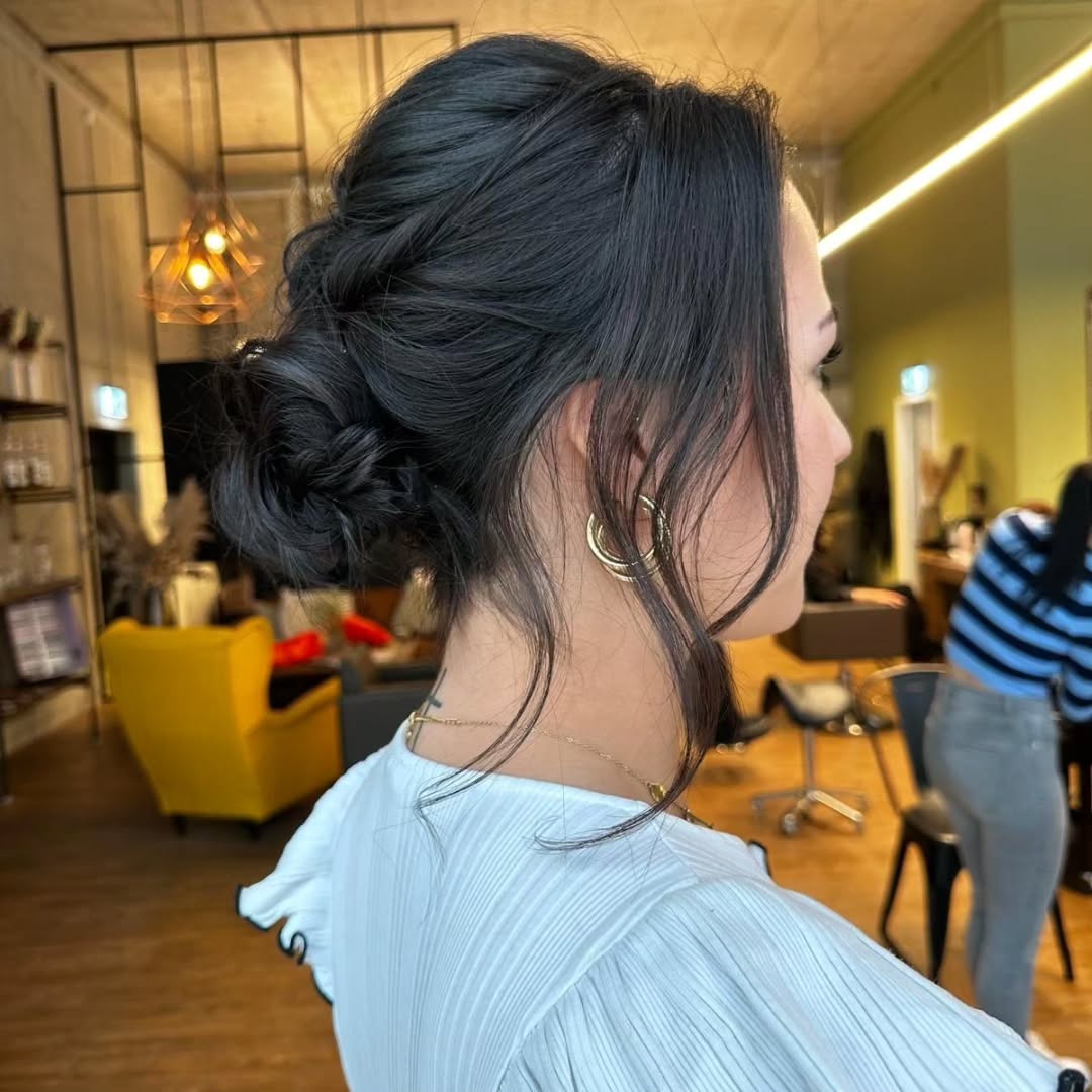 Textured Low Knotted Twist Updo with Curtain Tendrils