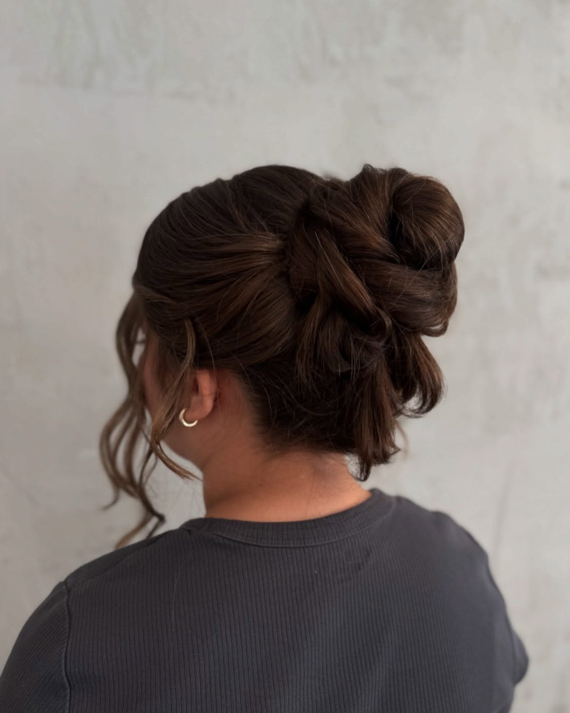 Textured Sectioned Knot Bun with Loose Face‑Framing Tendrils