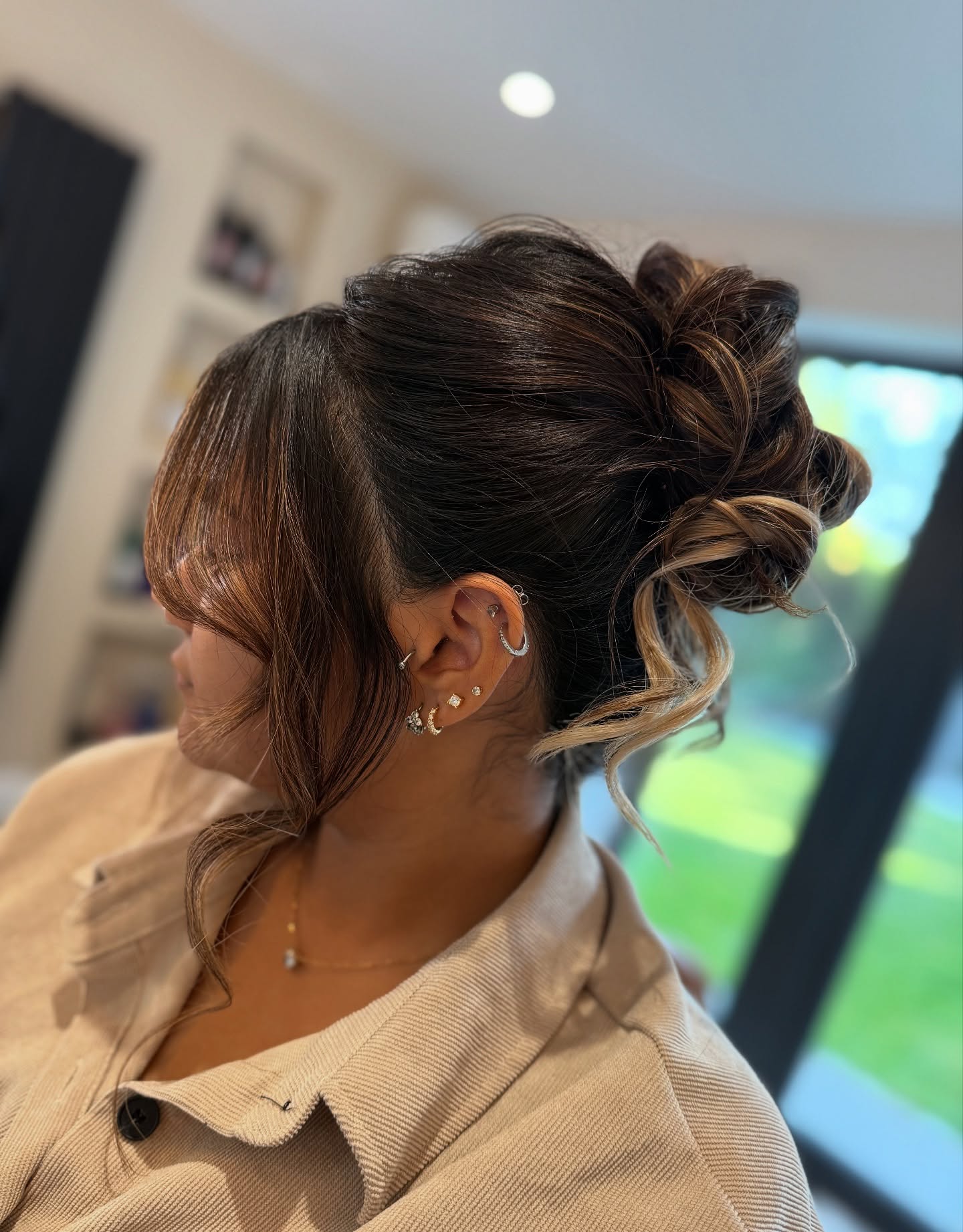 Textured Twisted Updo with Caramel Face‑Framing Balayage
