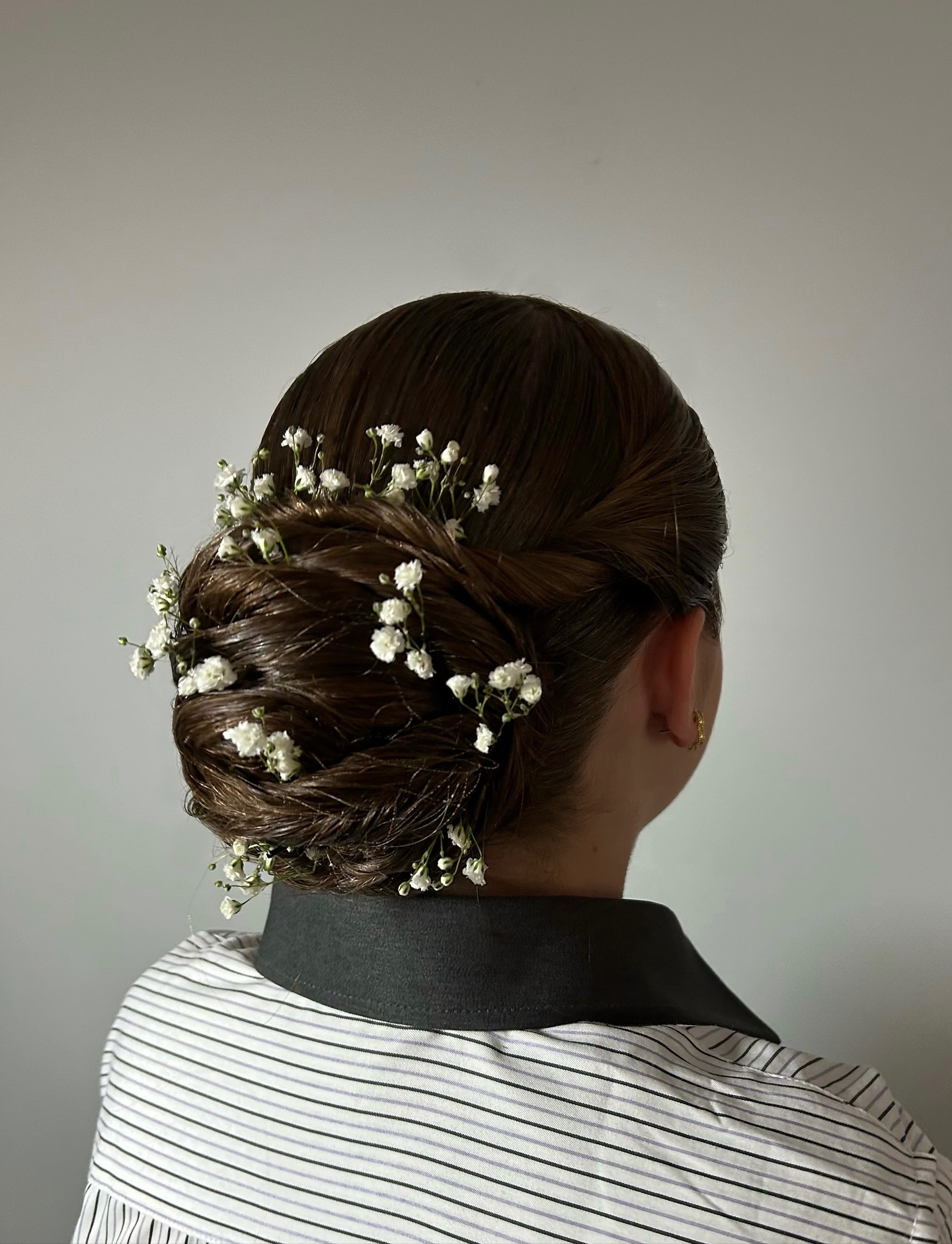 Twisted Rosette Low Chignon with Baby's Breath Accents