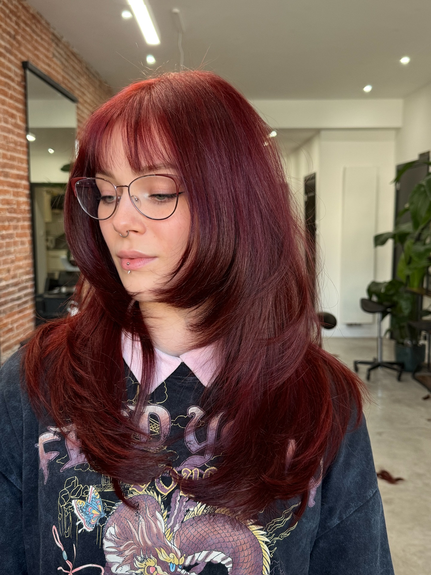 Deep Burgundy Rounded Layers with Wispy Face-Framing Fringe