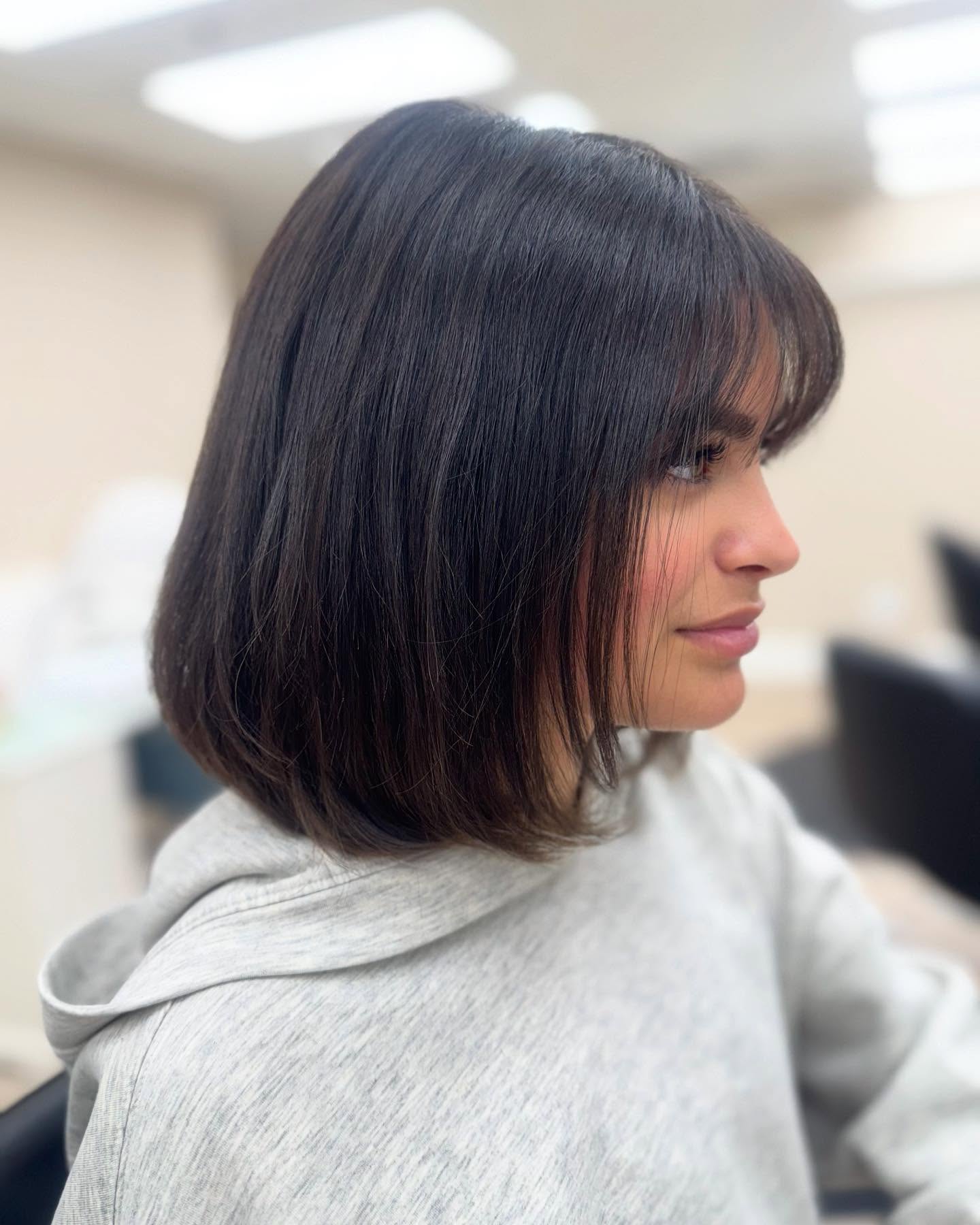 Glossy Shoulder-Length Blunt Bob with Wispy Fringe