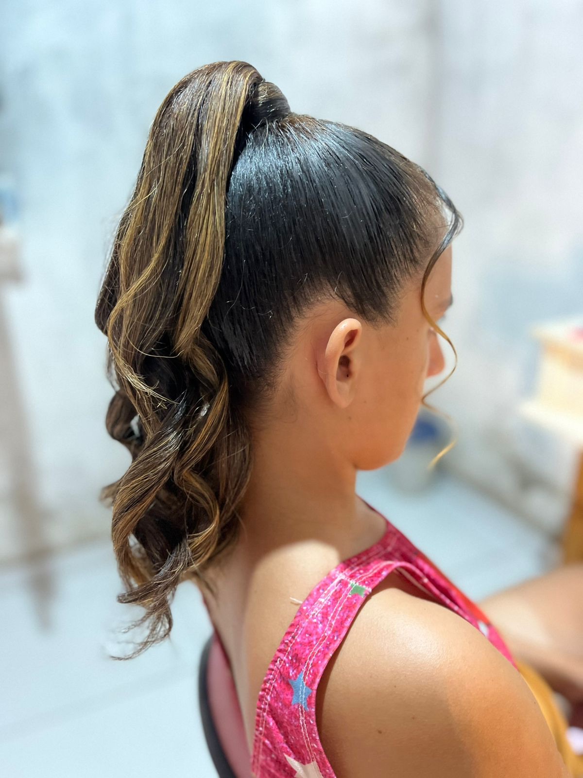 High-Gloss Pony with Caramel Balayage Wrap and Loose Spiral Tail