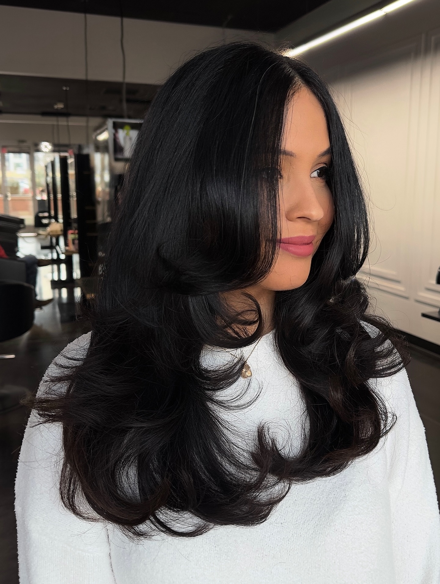 Long Black Feathered Layers with Face-Framing Curtain and Soft Roll