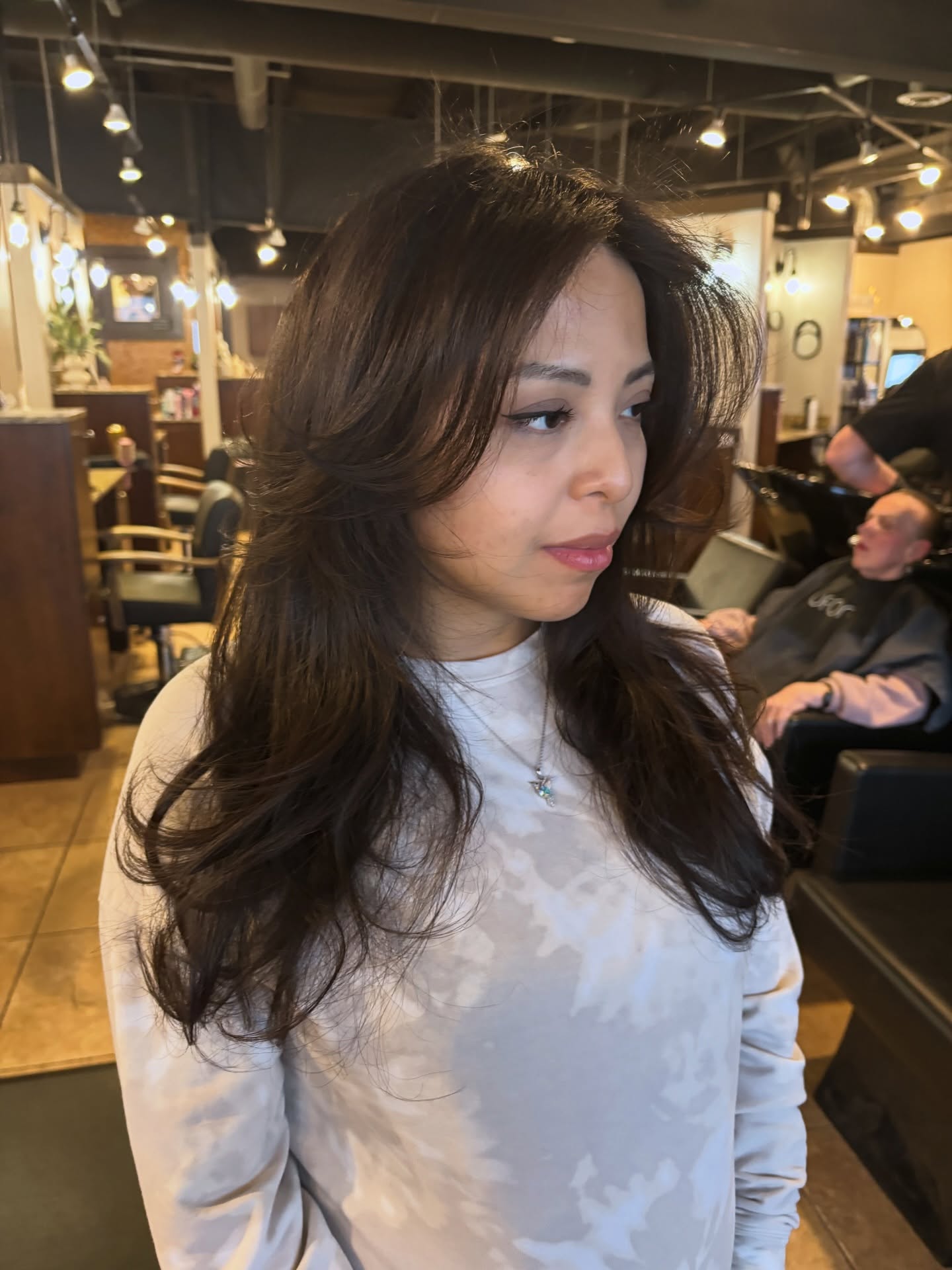 Long Chocolate Feathered Layers with Face-Framing and Root Lift