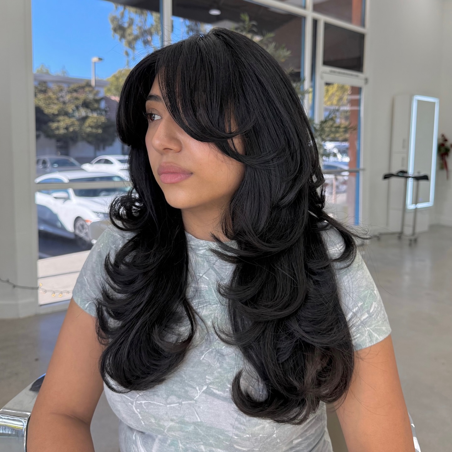 Long Voluminous Feathered Layers with Rounded Face‑Framing Bangs