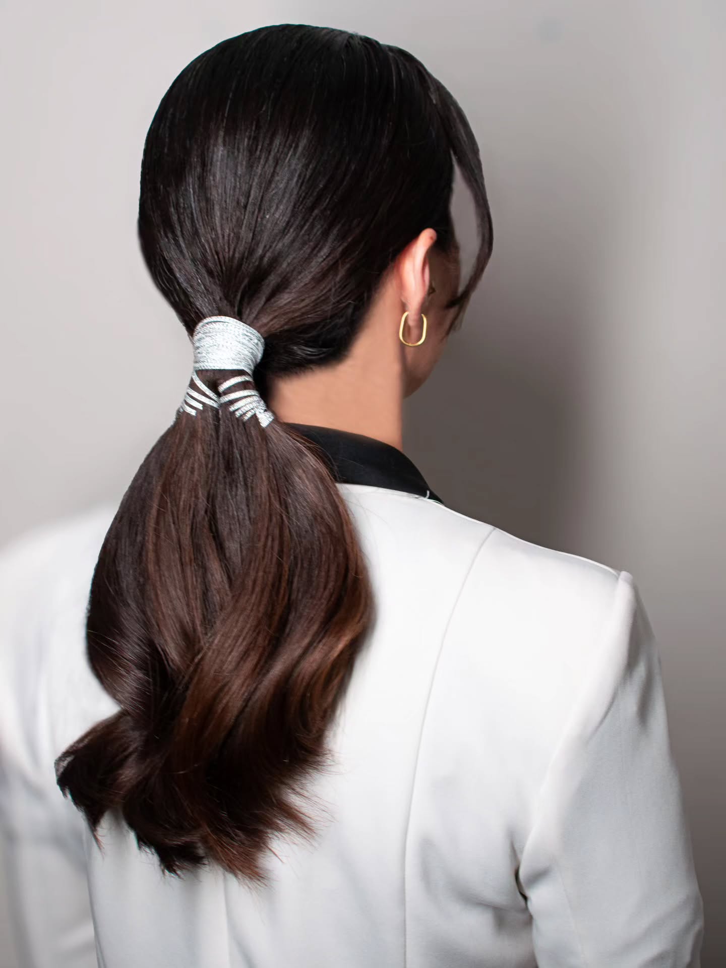 Low Wrapped Ponytail with Metallic Cord Accent